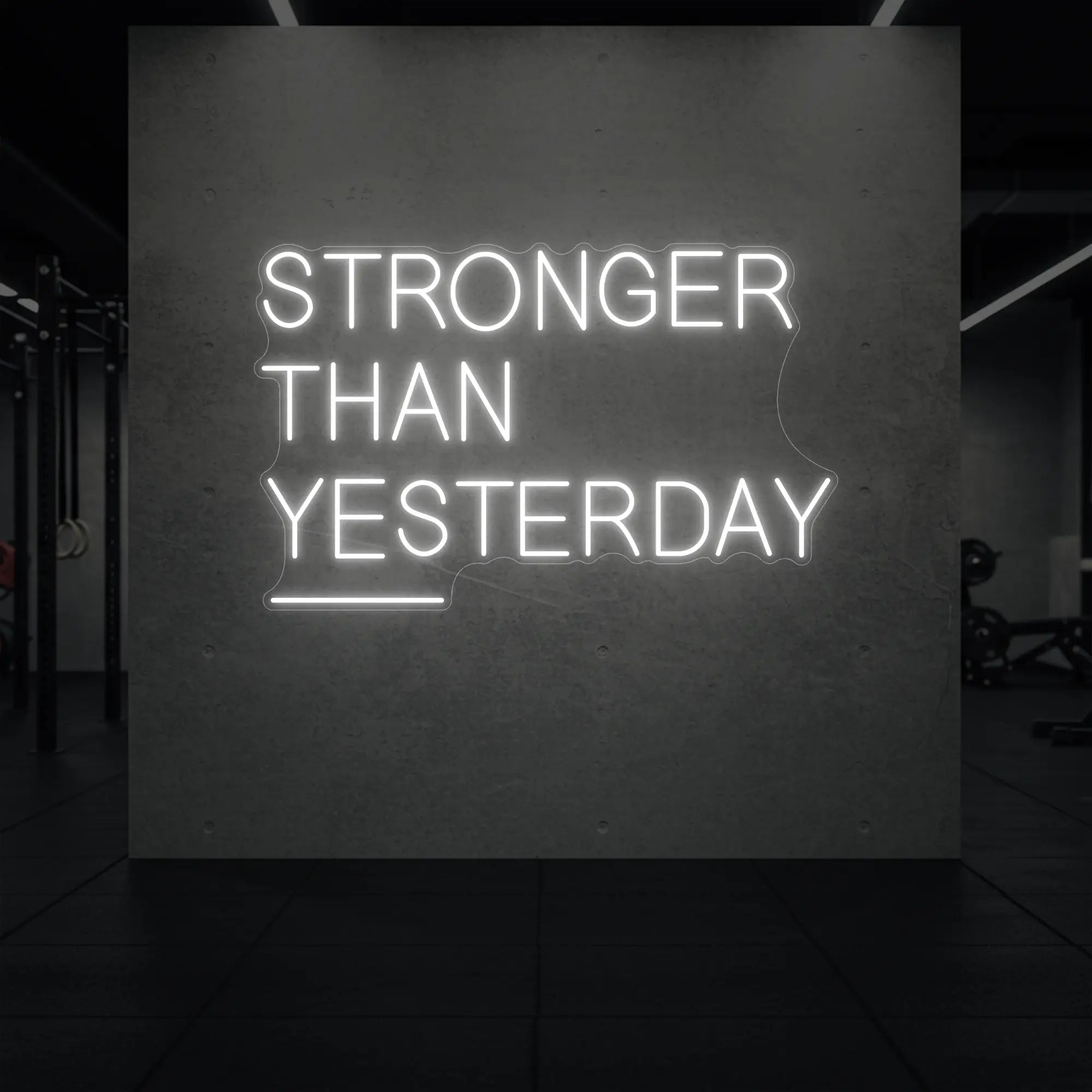 'Stronger Than Yesterday' neon sign glowing in cool white against a styled interior wall.