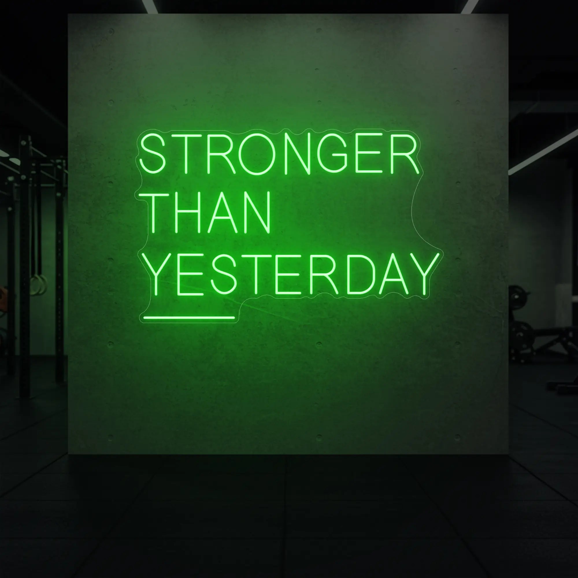 'Stronger Than Yesterday' neon sign glowing in green against a styled interior wall.
