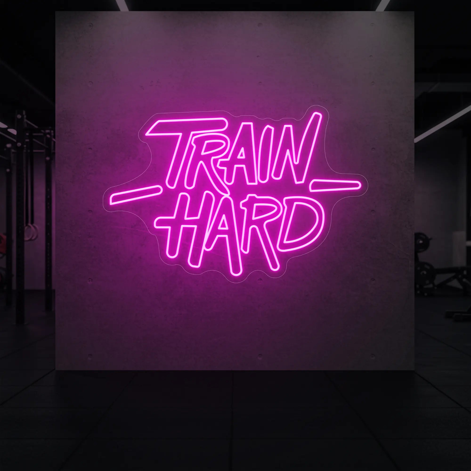 'TRAIN HARD' neon sign glowing in light pink against a styled interior wall.