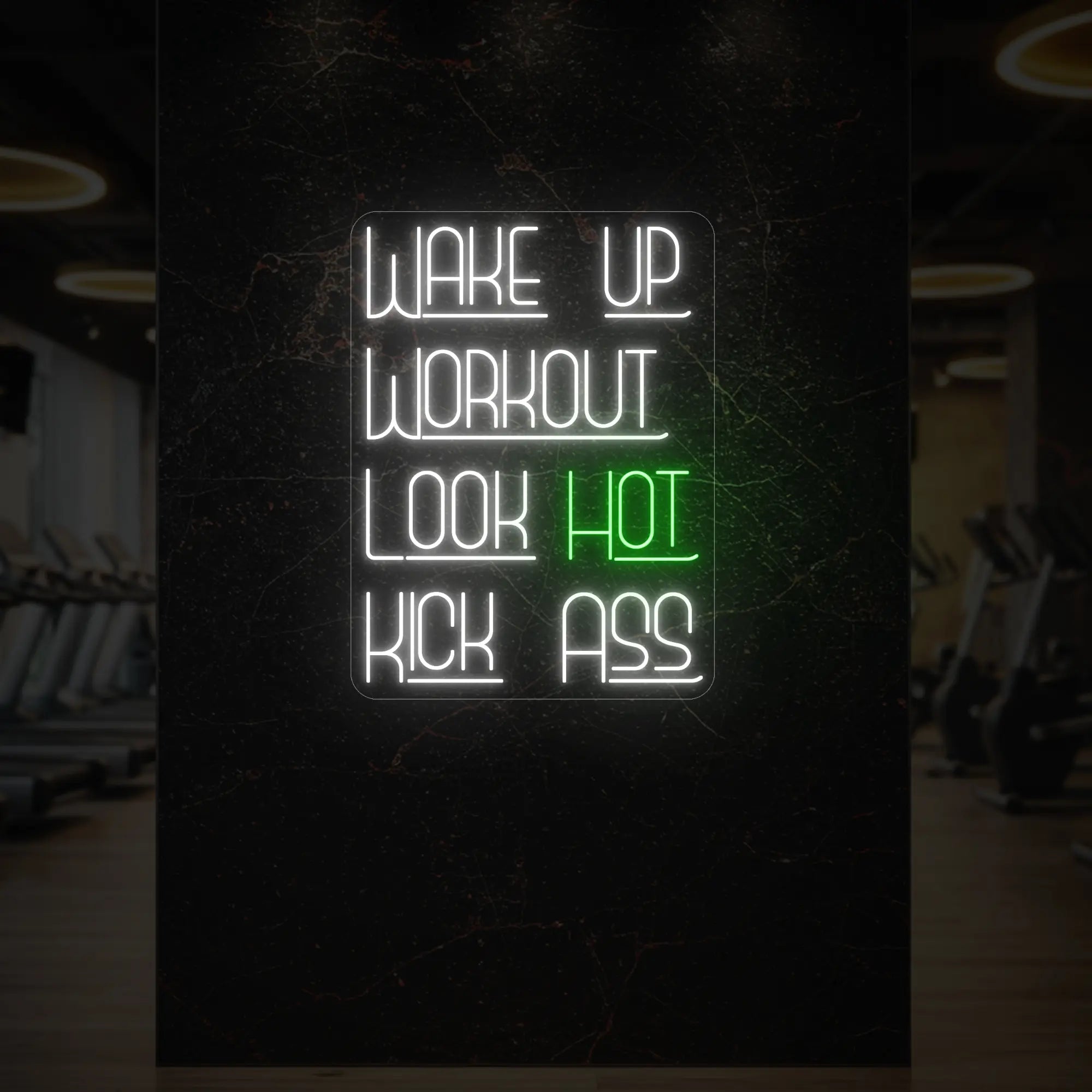 'WAKE UP WORKOUT LOOK HOT KICK ASS' neon sign glowing in green against a styled interior wall.