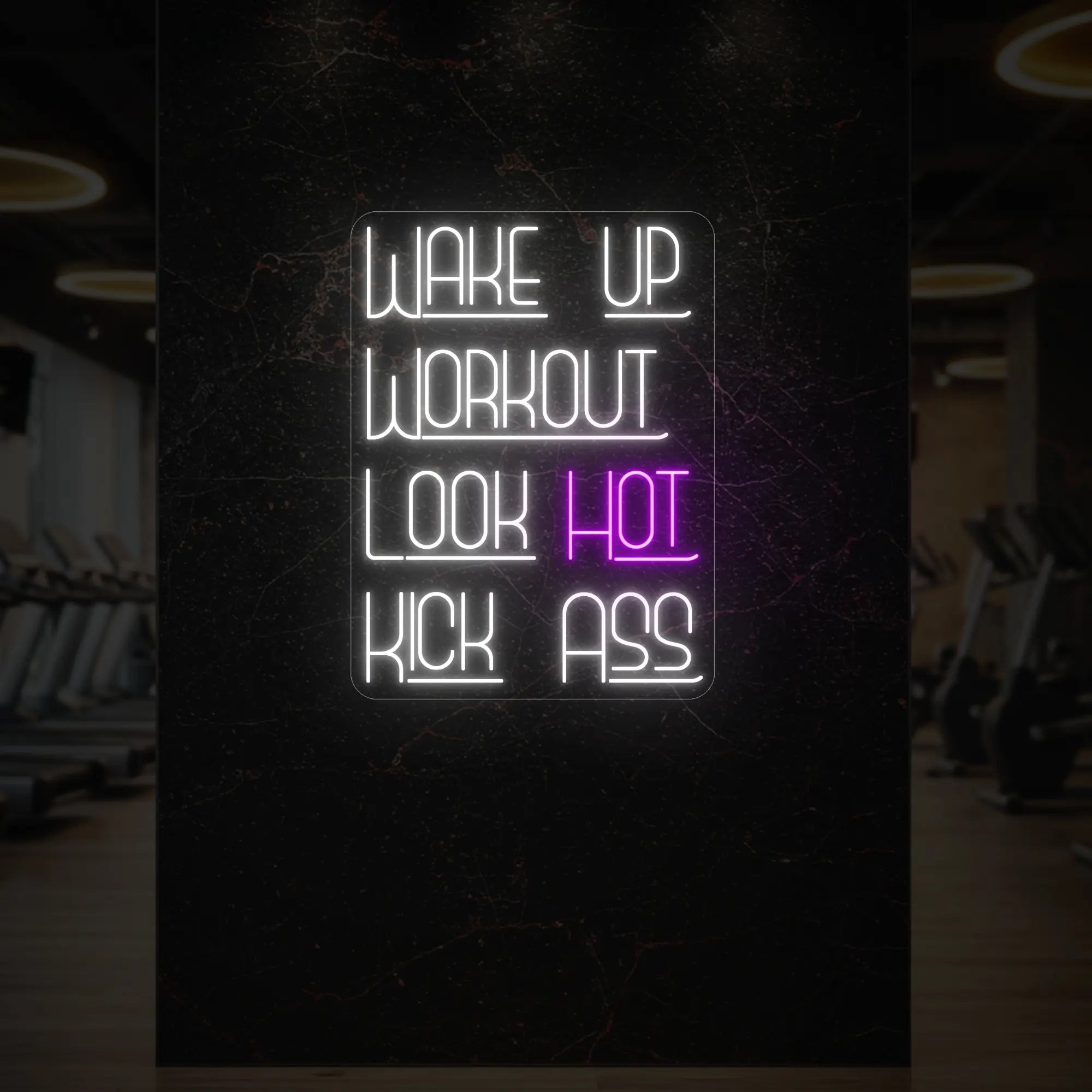 'WAKE UP WORKOUT LOOK HOT KICK ASS' neon sign glowing in deep pink against a styled interior wall.