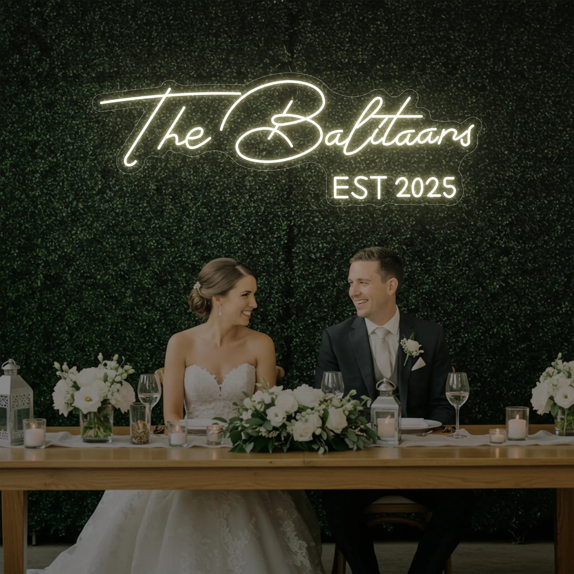Photo of the 'Wedding Last Names Custom Neon Sign V1' neon sign glowing in warm white against a styled interior wall.