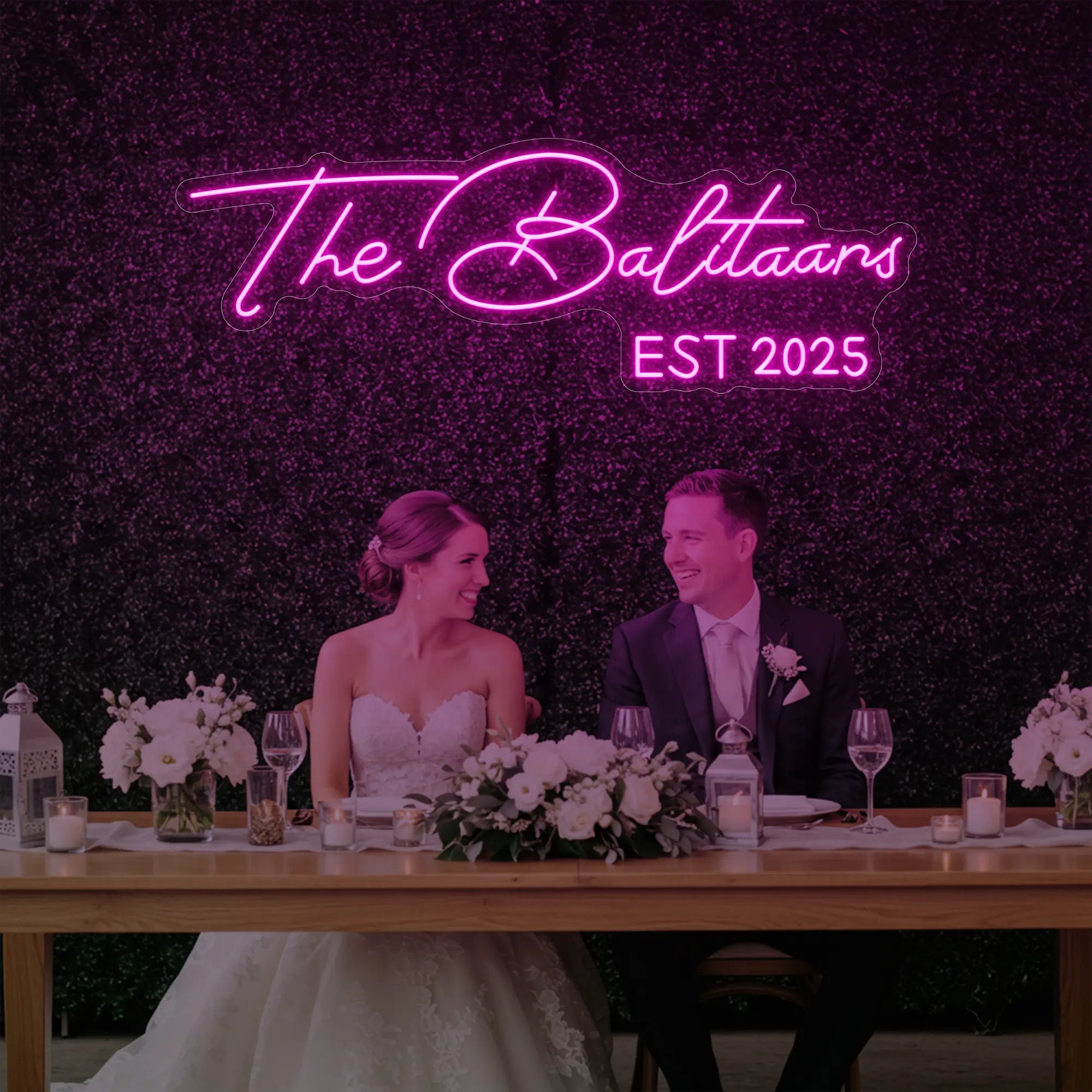 Photo of the 'Wedding Last Names Custom Neon Sign V1' neon sign glowing in light pink against a styled interior wall.