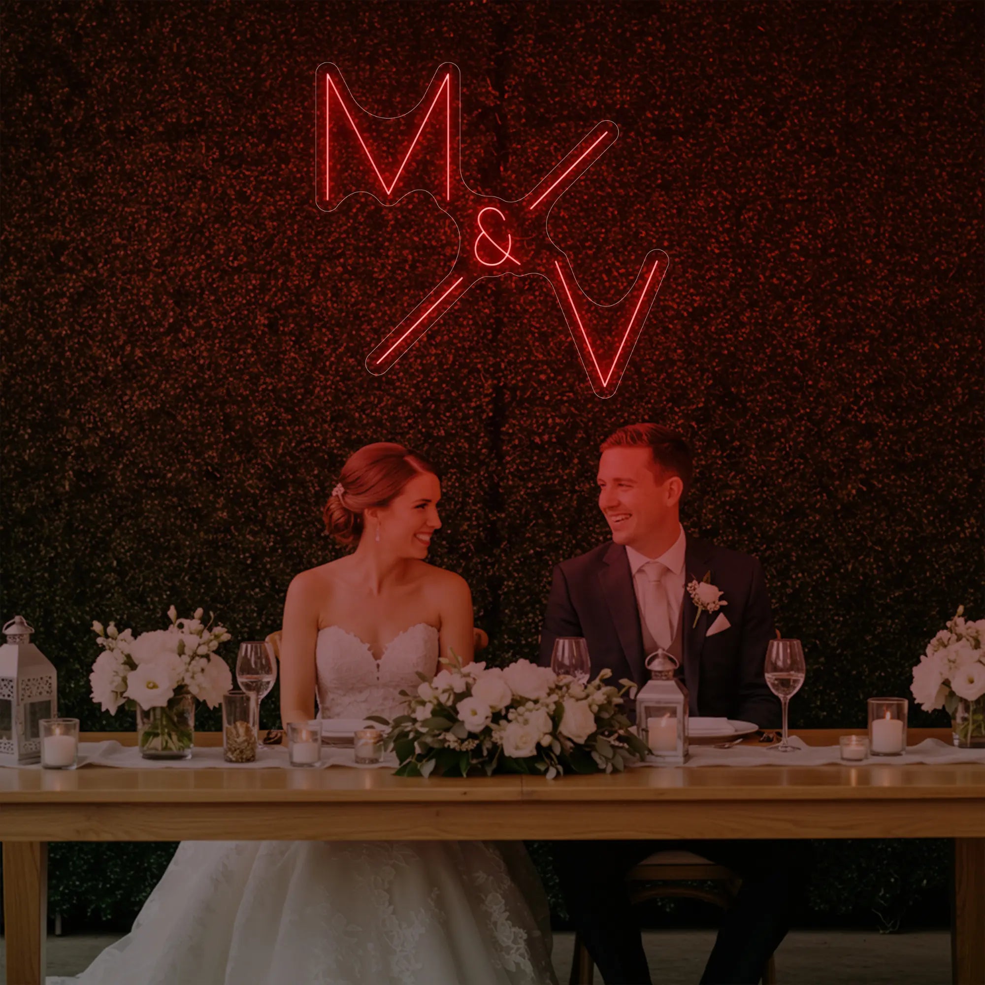 Photo of the 'Wedding Initials Custom Neon Sign V1' neon sign glowing in red against a styled interior wall.