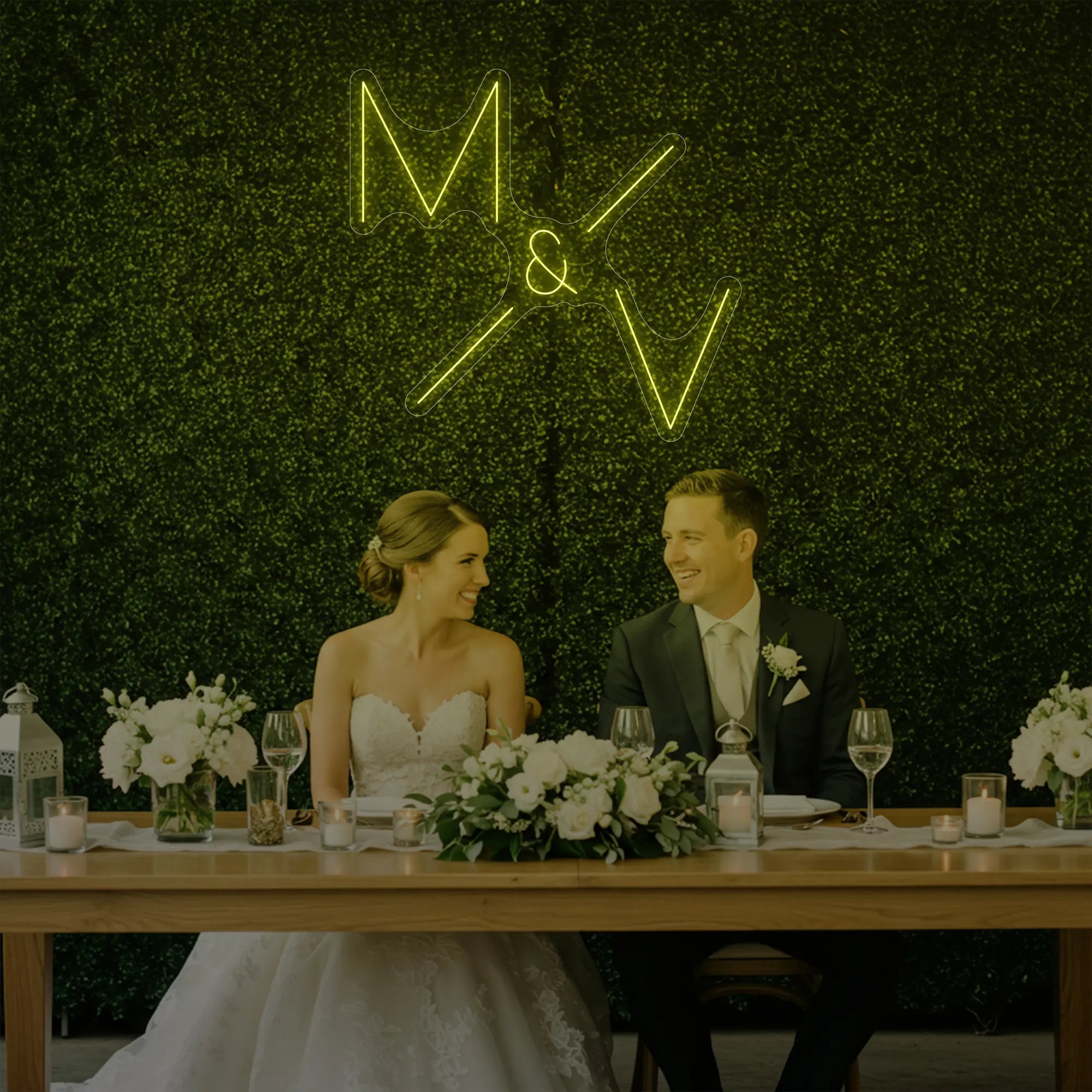 Photo of the 'Wedding Initials Custom Neon Sign V1' neon sign glowing in lemon yellow against a styled interior wall.