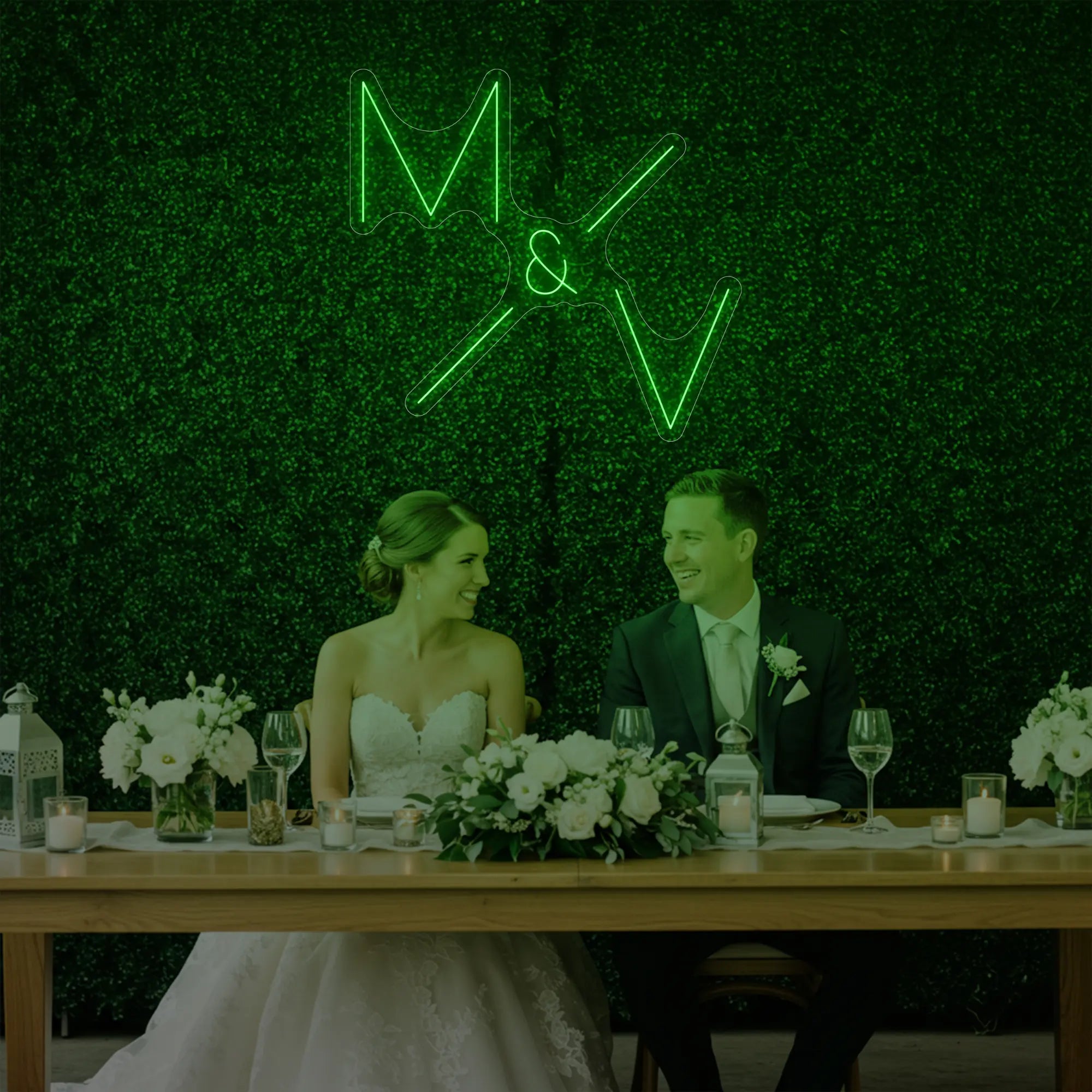 Photo of the 'Wedding Initials Custom Neon Sign V1' neon sign glowing in green against a styled interior wall.