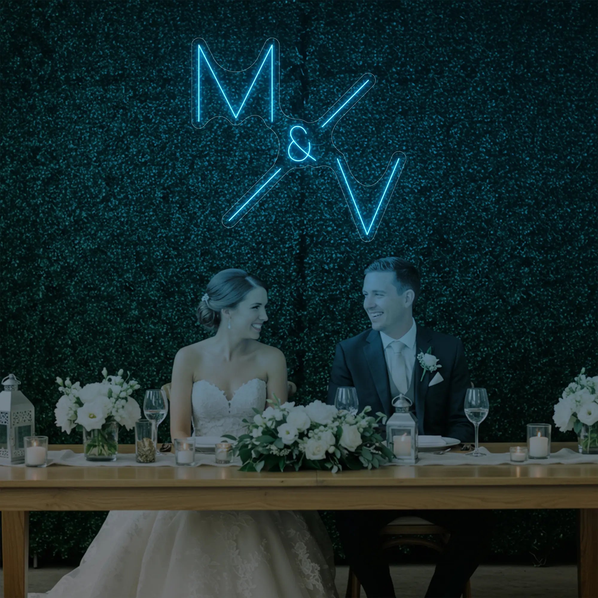 Photo of the 'Wedding Initials Custom Neon Sign V1' neon sign glowing in ice blue against a styled interior wall.