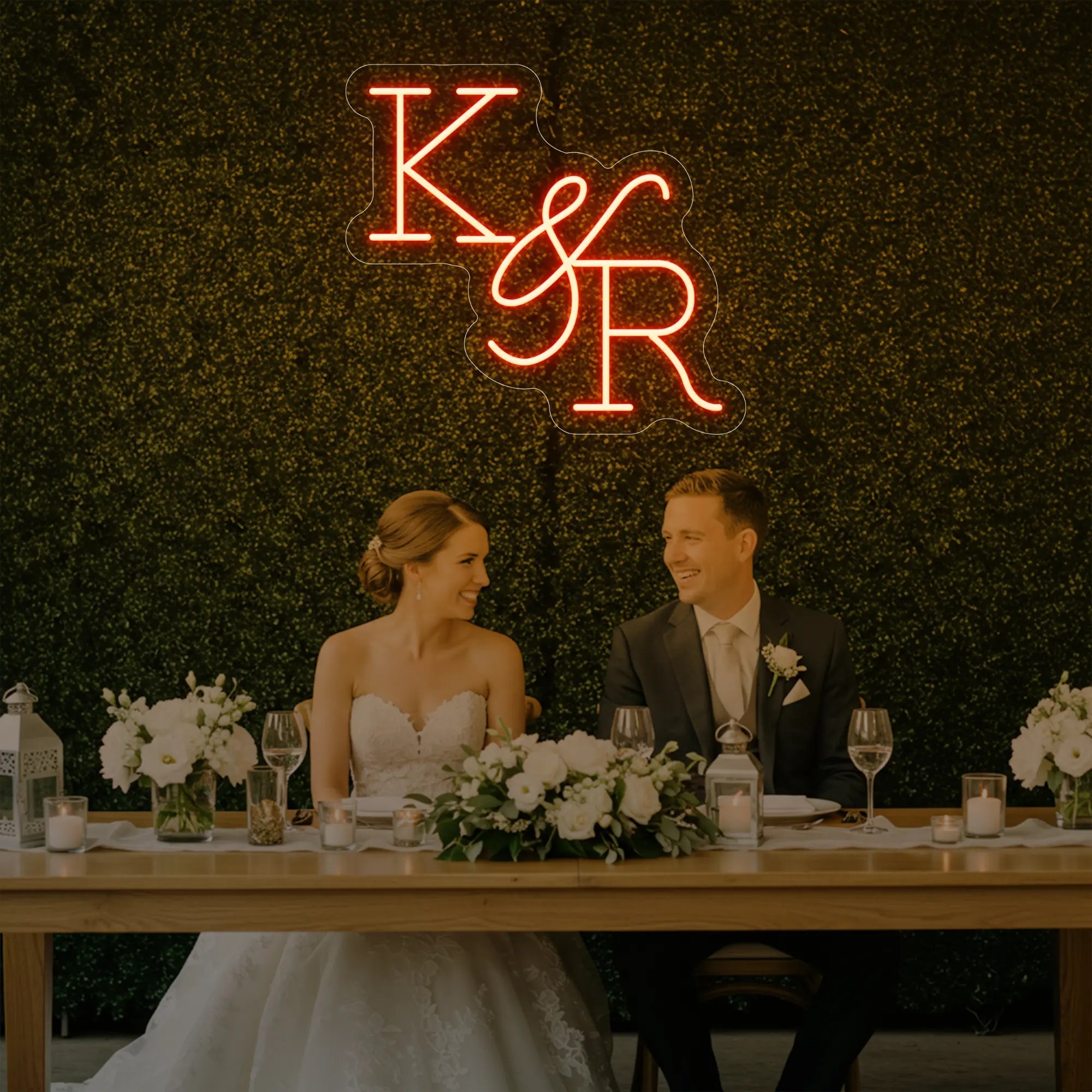 Photo of the 'Wedding Initials Custom Neon Sign V2' neon sign glowing in golden yellow against a styled interior wall.