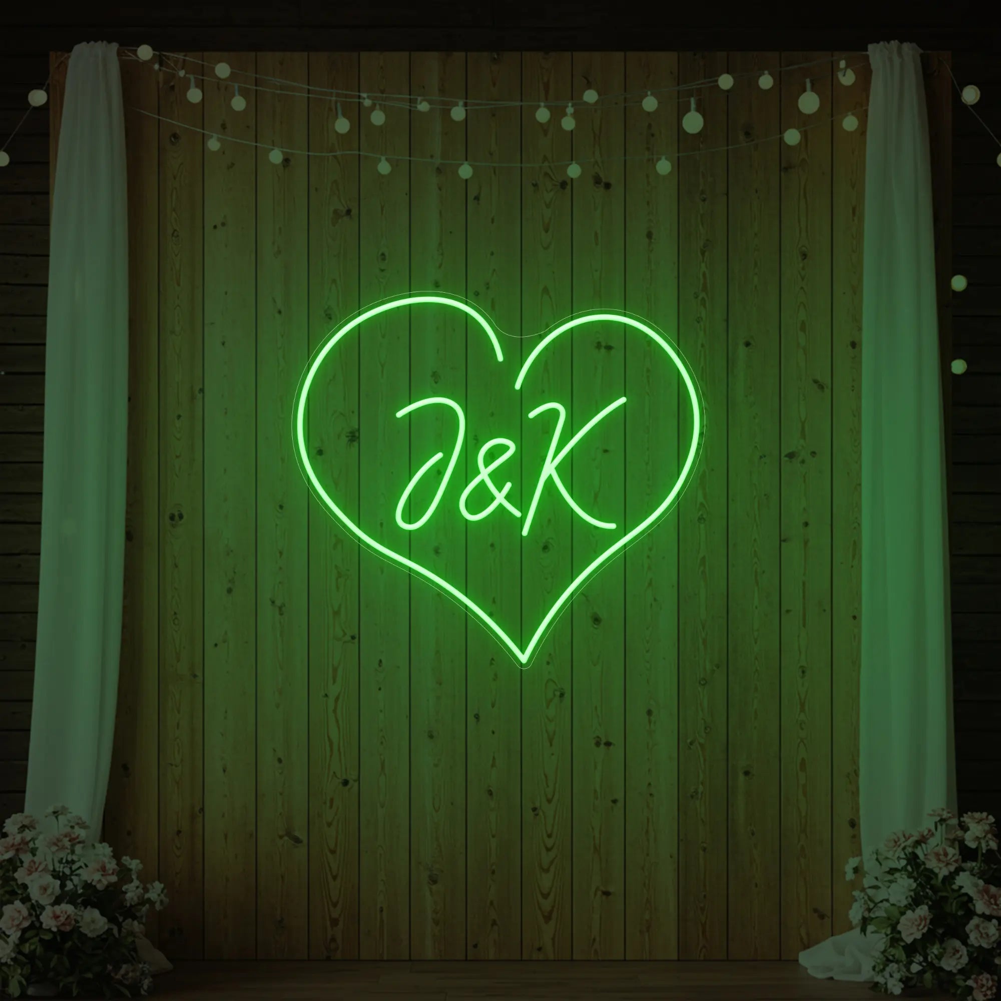Photo of the 'Wedding Initials Custom Neon Sign V5' neon sign glowing in green against a styled interior wall.