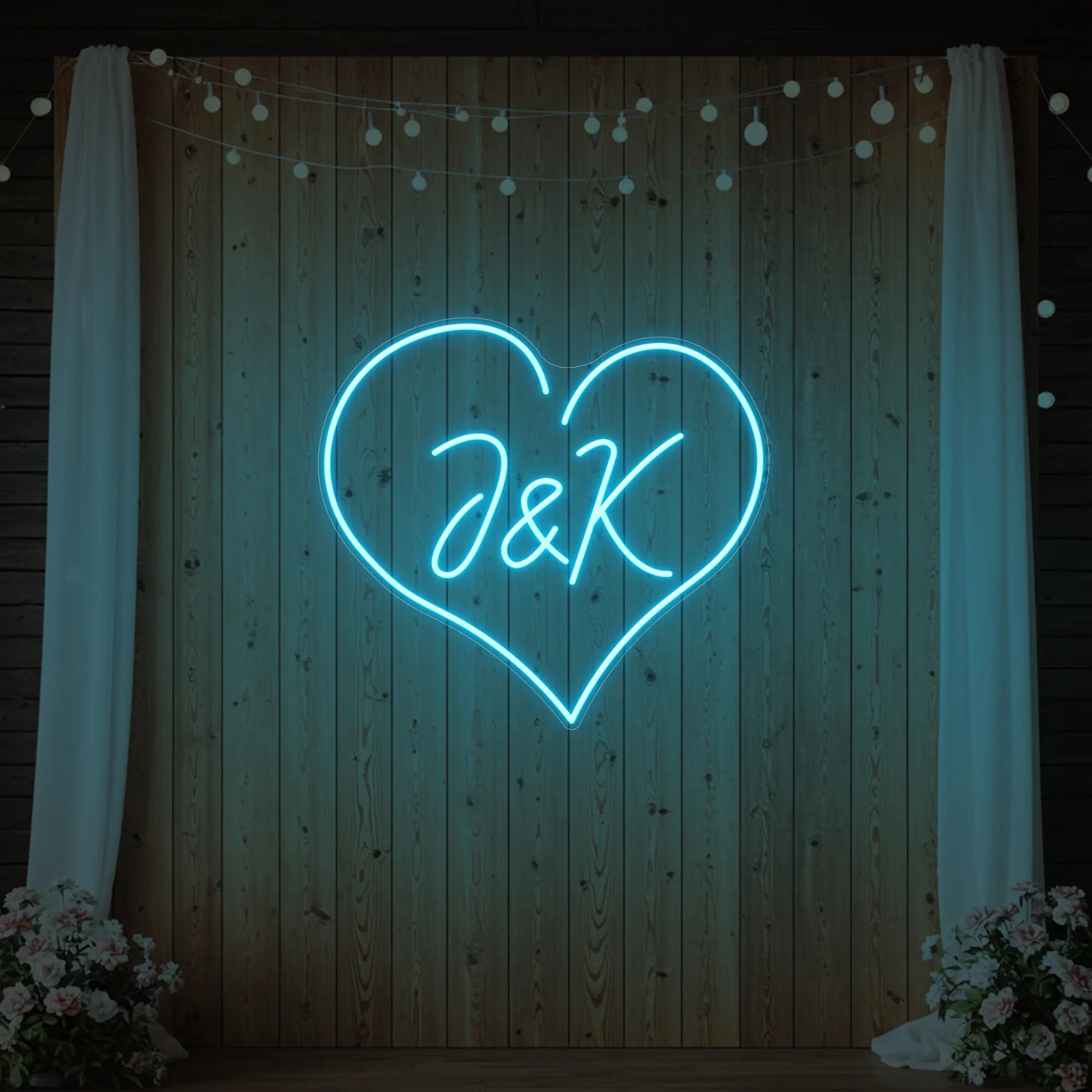 Photo of the 'Wedding Initials Custom Neon Sign V5' neon sign glowing in ice blue against a styled interior wall.
