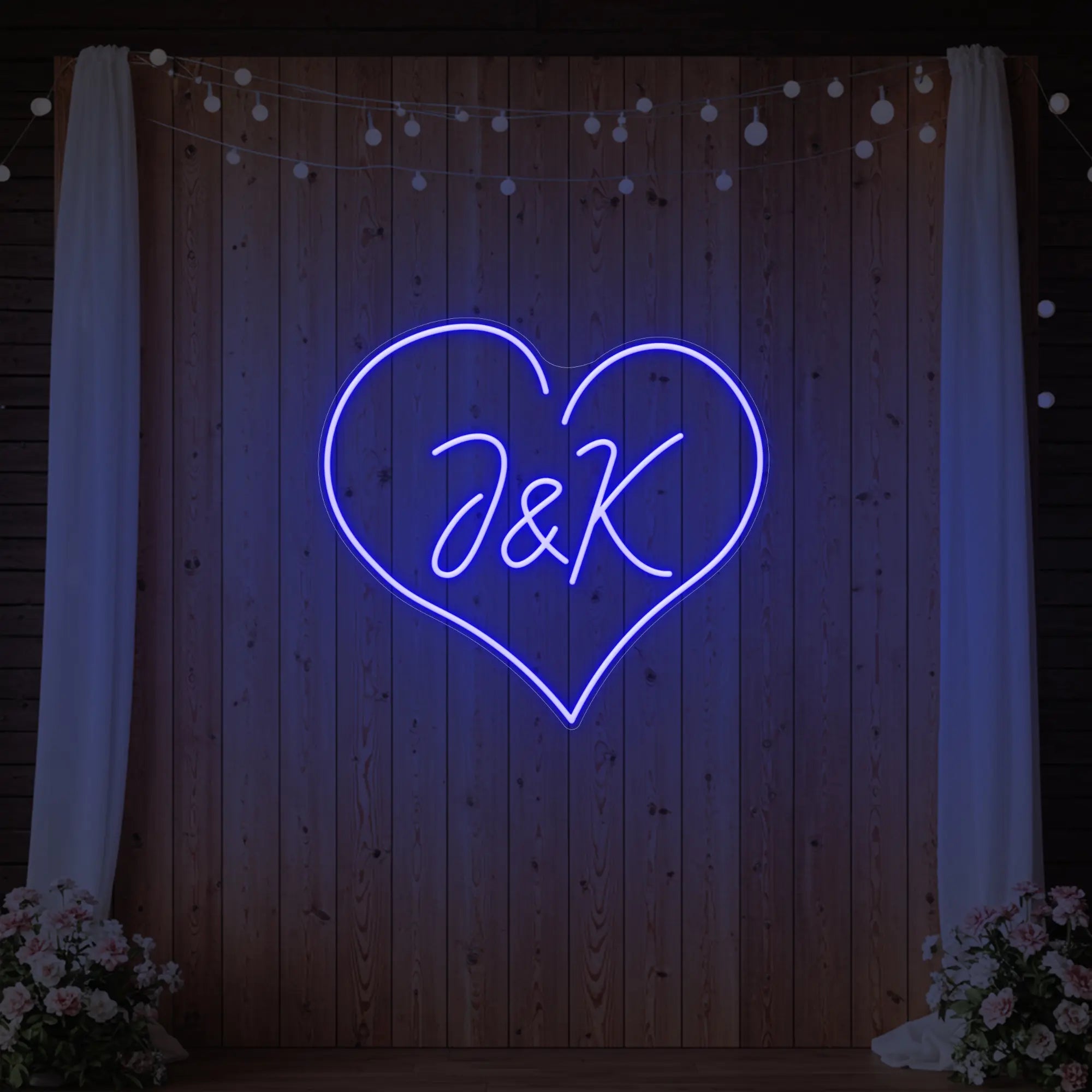 Photo of the 'Wedding Initials Custom Neon Sign V5' neon sign glowing in deep blue against a styled interior wall.