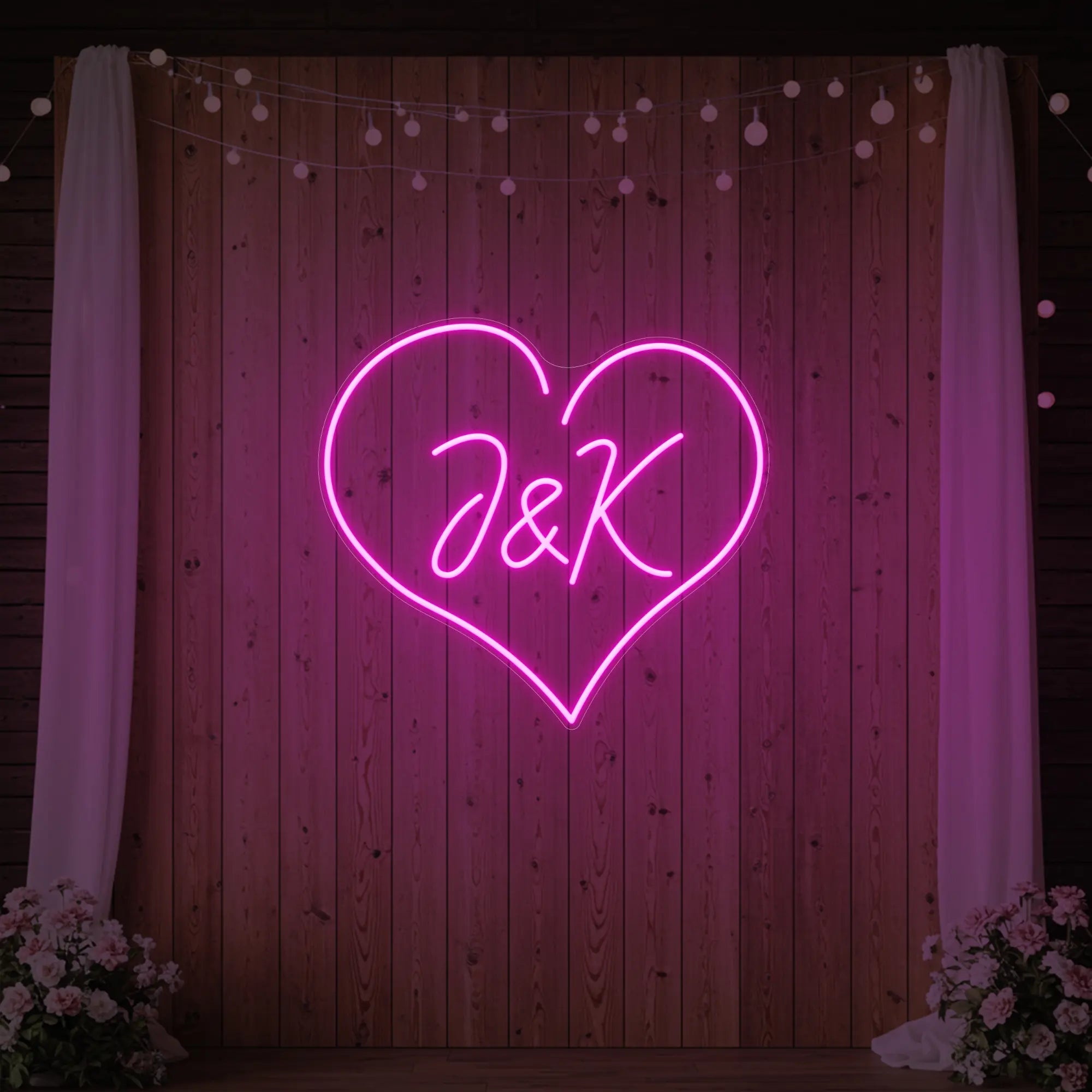 Photo of the 'Wedding Initials Custom Neon Sign V5' neon sign glowing in light pink against a styled interior wall.