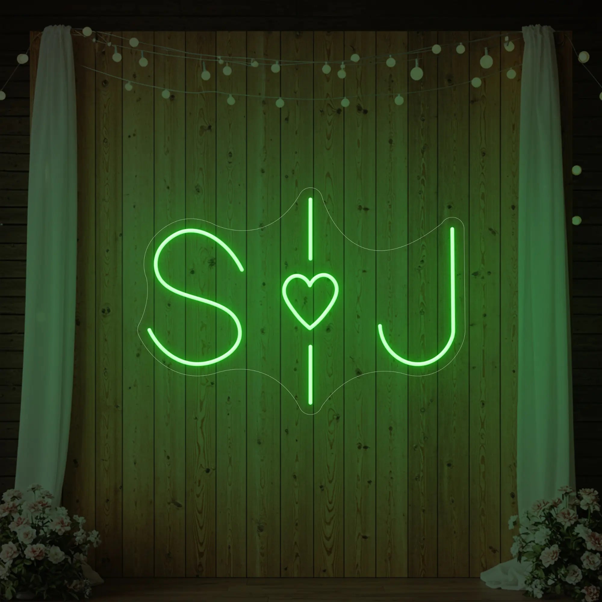 Photo of the 'Wedding Initials Custom Neon Sign V6' neon sign glowing in green against a styled interior wall.