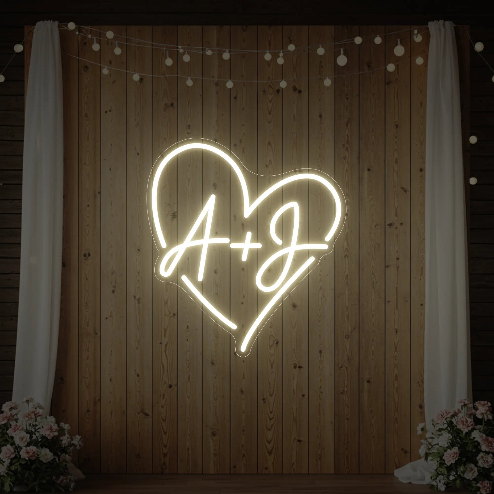 Photo of the 'Wedding Initials Custom Neon Sign V7' neon sign glowing in warm white against a styled interior wall.