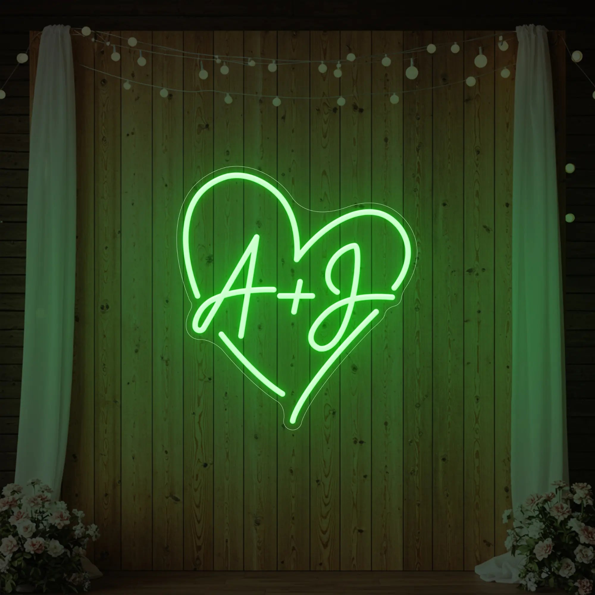 Photo of the 'Wedding Initials Custom Neon Sign V7' neon sign glowing in green against a styled interior wall.
