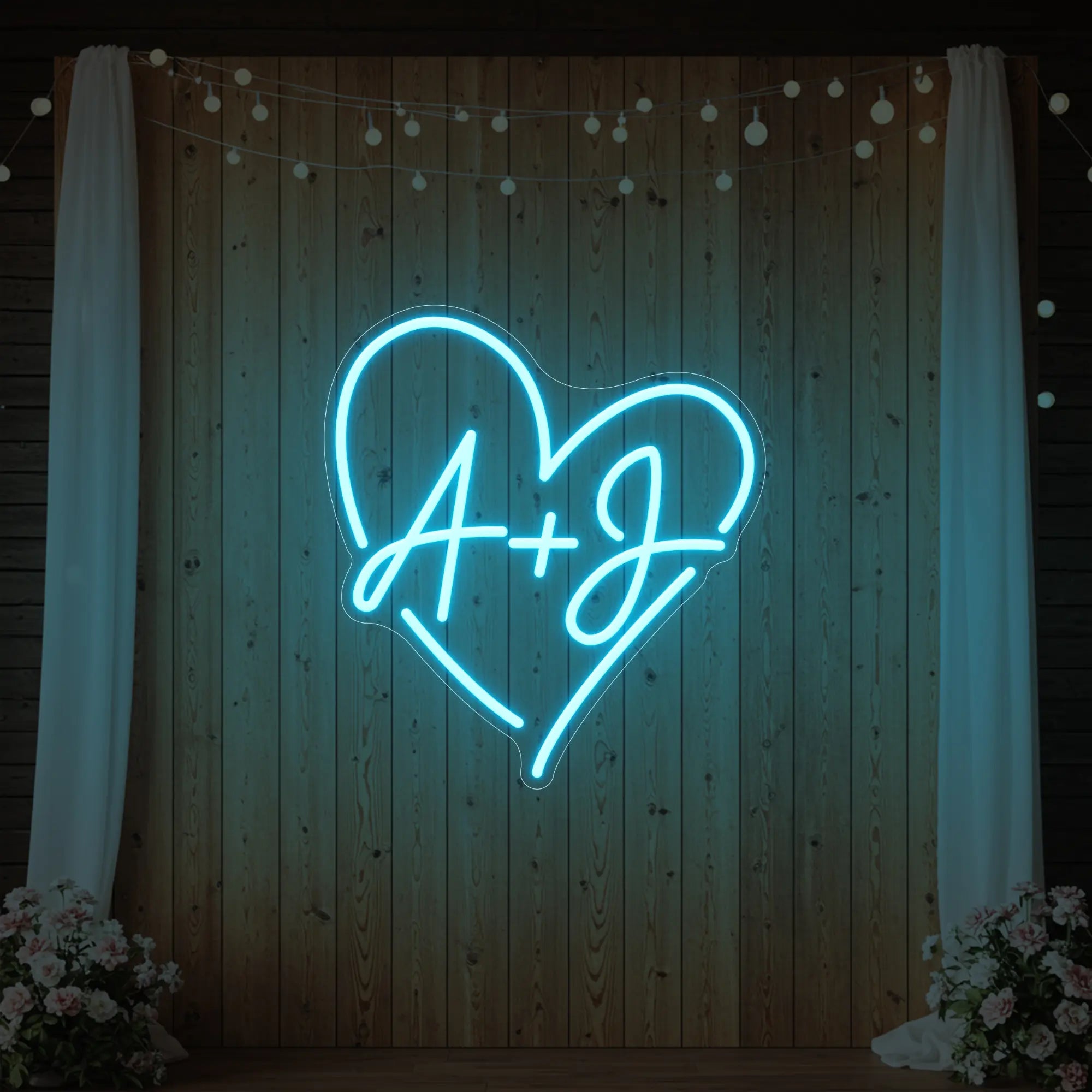 Photo of the 'Wedding Initials Custom Neon Sign V7' neon sign glowing in ice blue against a styled interior wall.