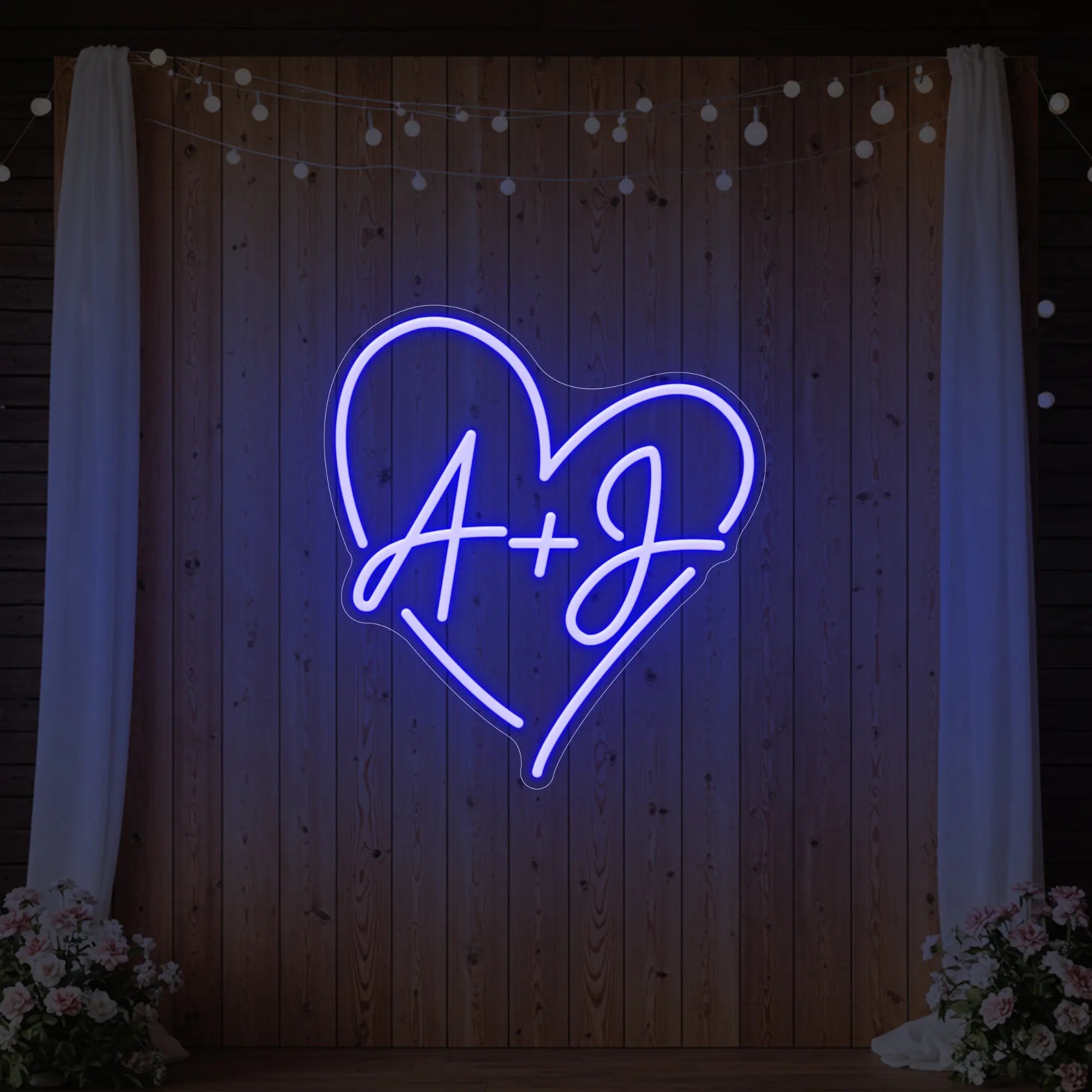 Photo of the 'Wedding Initials Custom Neon Sign V7' neon sign glowing in deep blue against a styled interior wall.