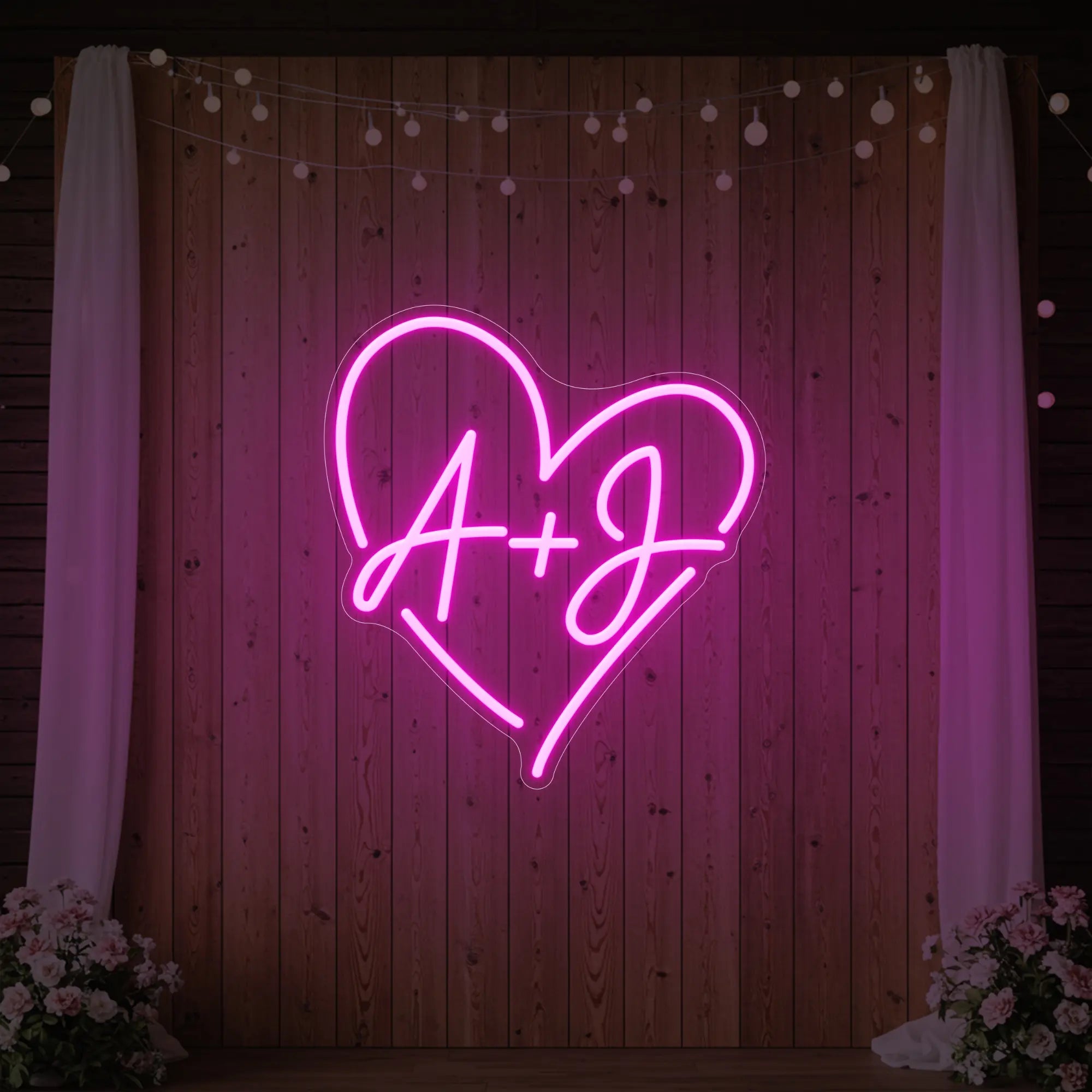 Photo of the 'Wedding Initials Custom Neon Sign V7' neon sign glowing in light pink against a styled interior wall.