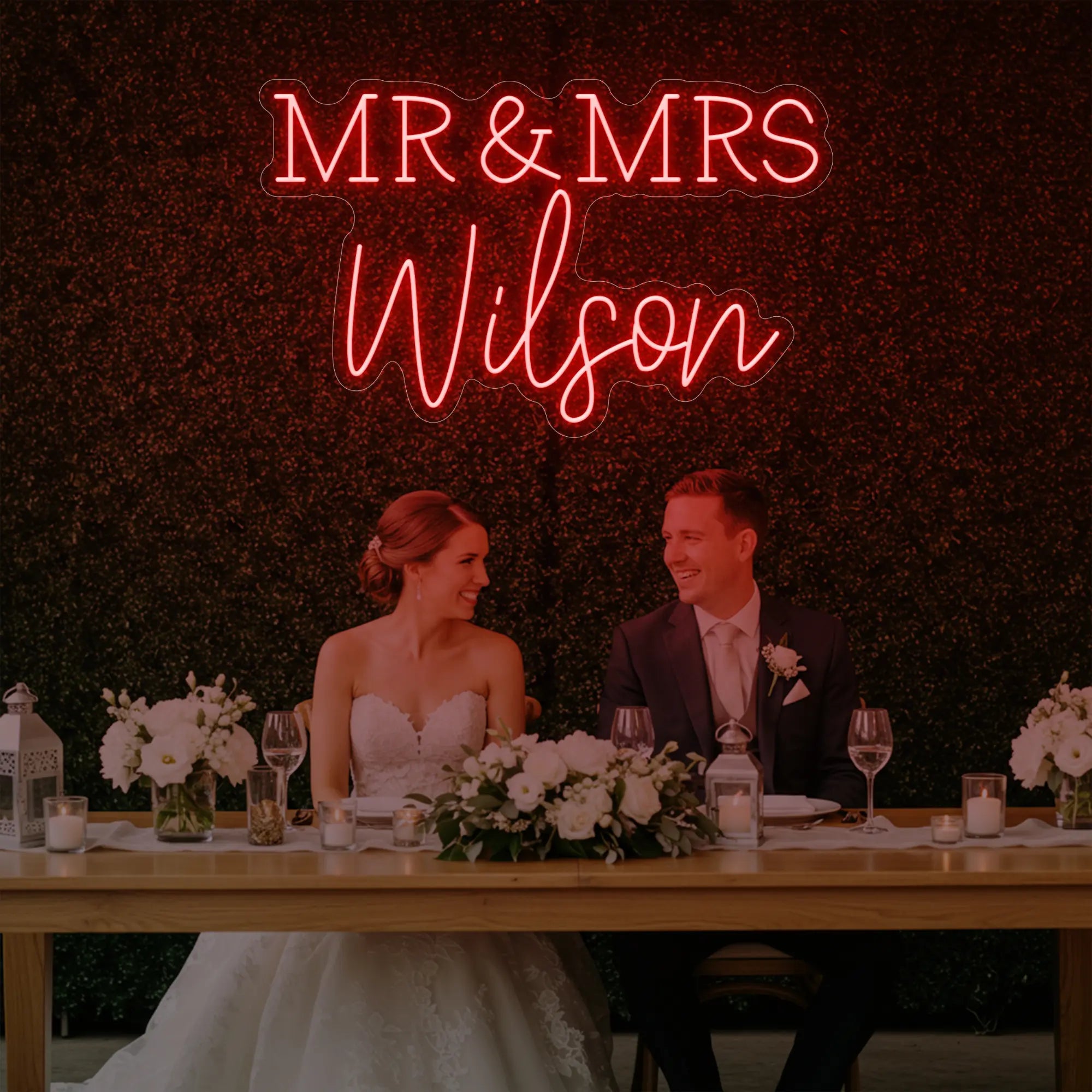 Photo of the 'Wedding Last Names Custom Neon Sign V2' neon sign glowing in red against a styled interior wall.