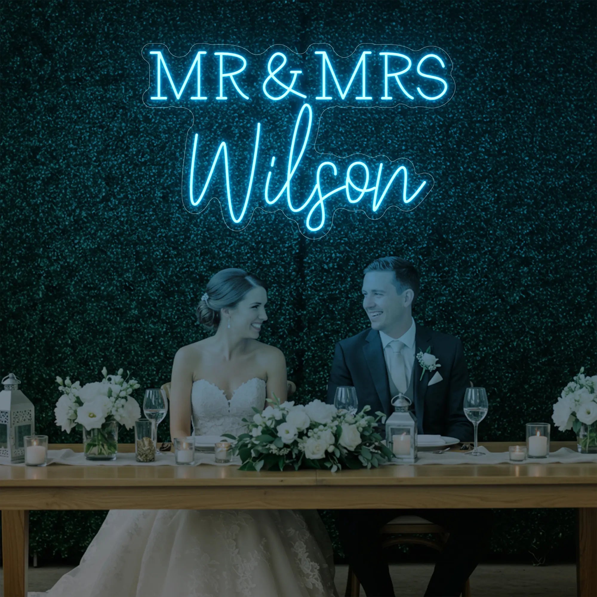 Photo of the 'Wedding Last Names Custom Neon Sign V2' neon sign glowing in ice blue against a styled interior wall.