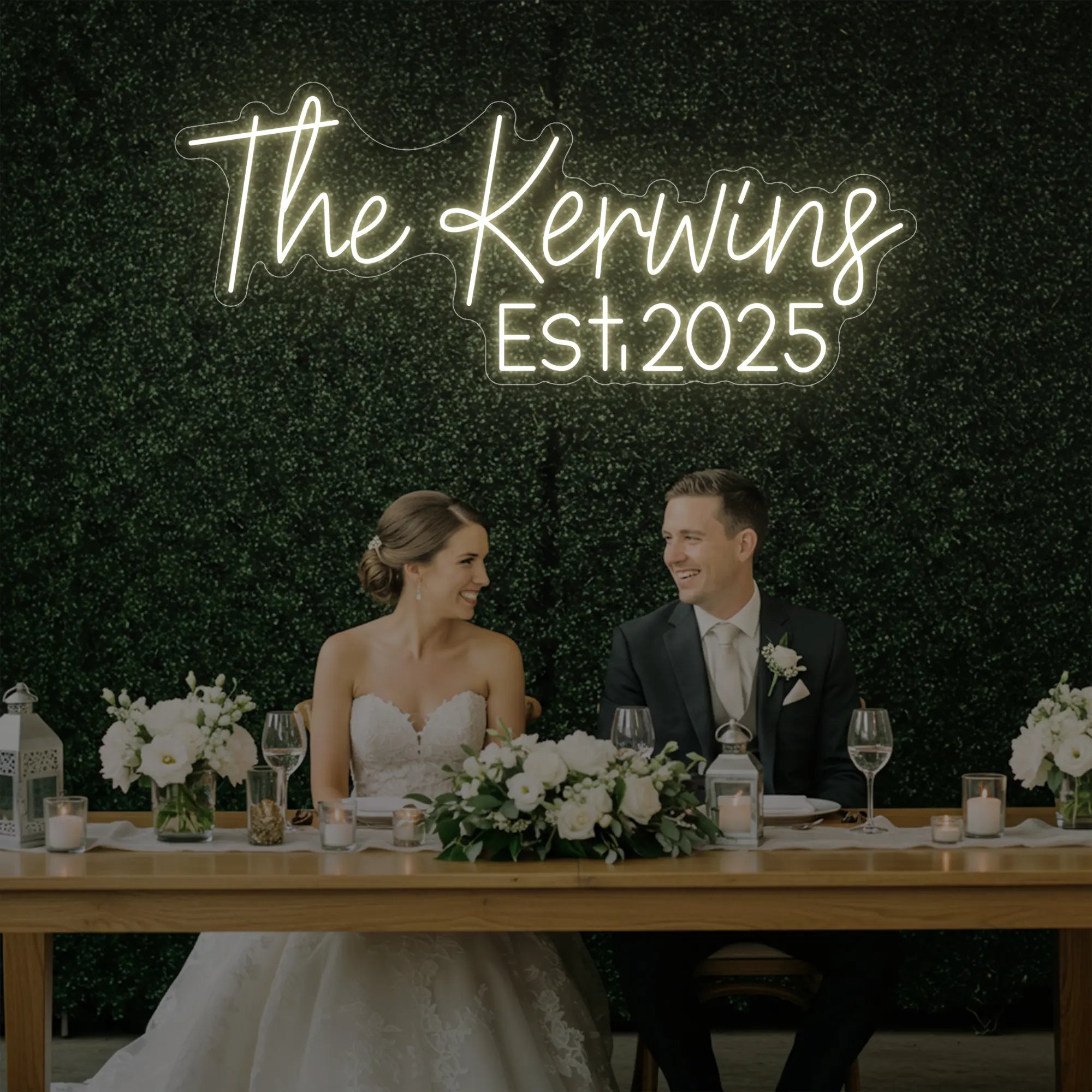 Photo of the 'Wedding Last Names Custom Neon Sign V5' neon sign glowing in warm white against a styled interior wall.