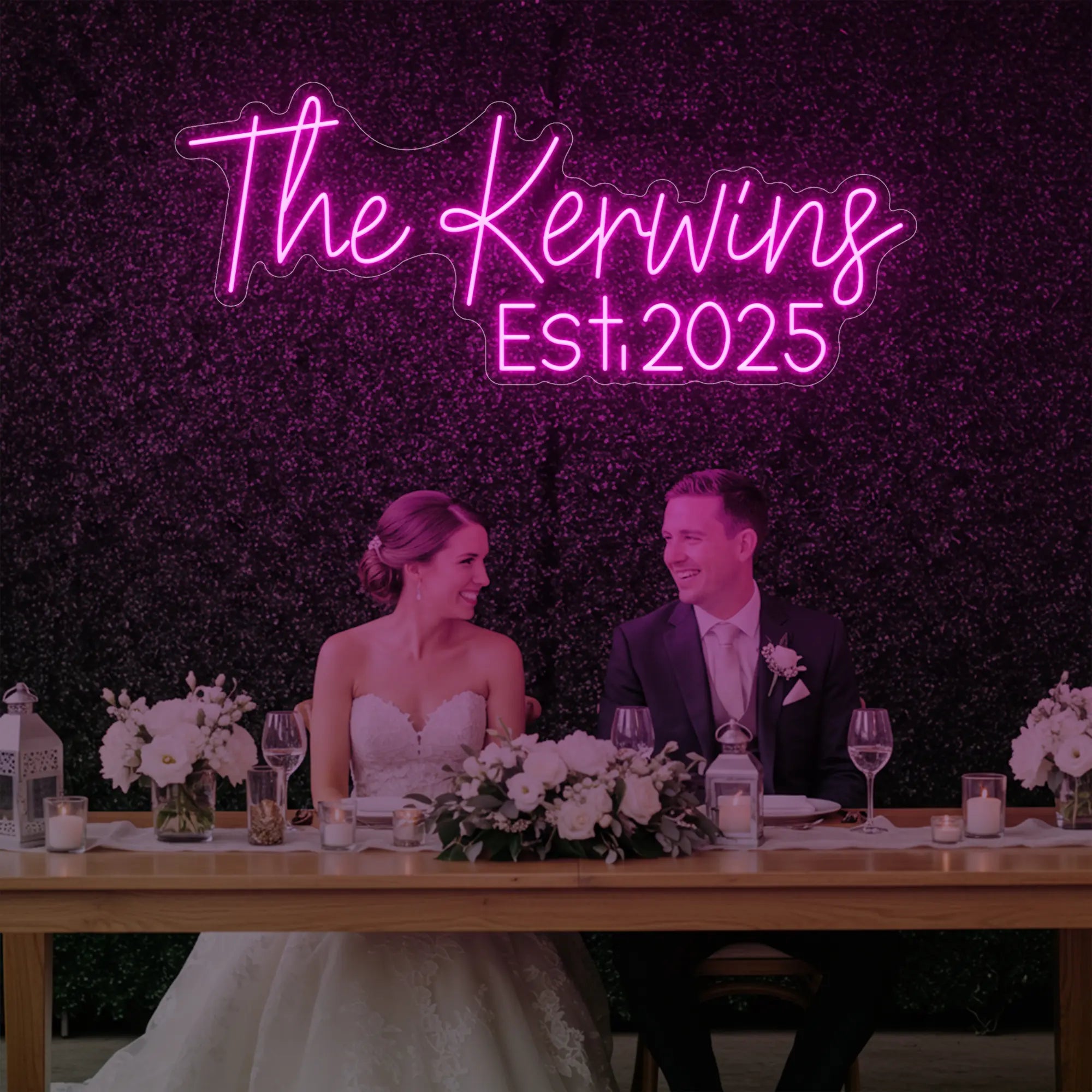 Photo of the 'Wedding Last Names Custom Neon Sign V5' neon sign glowing in light pink against a styled interior wall.