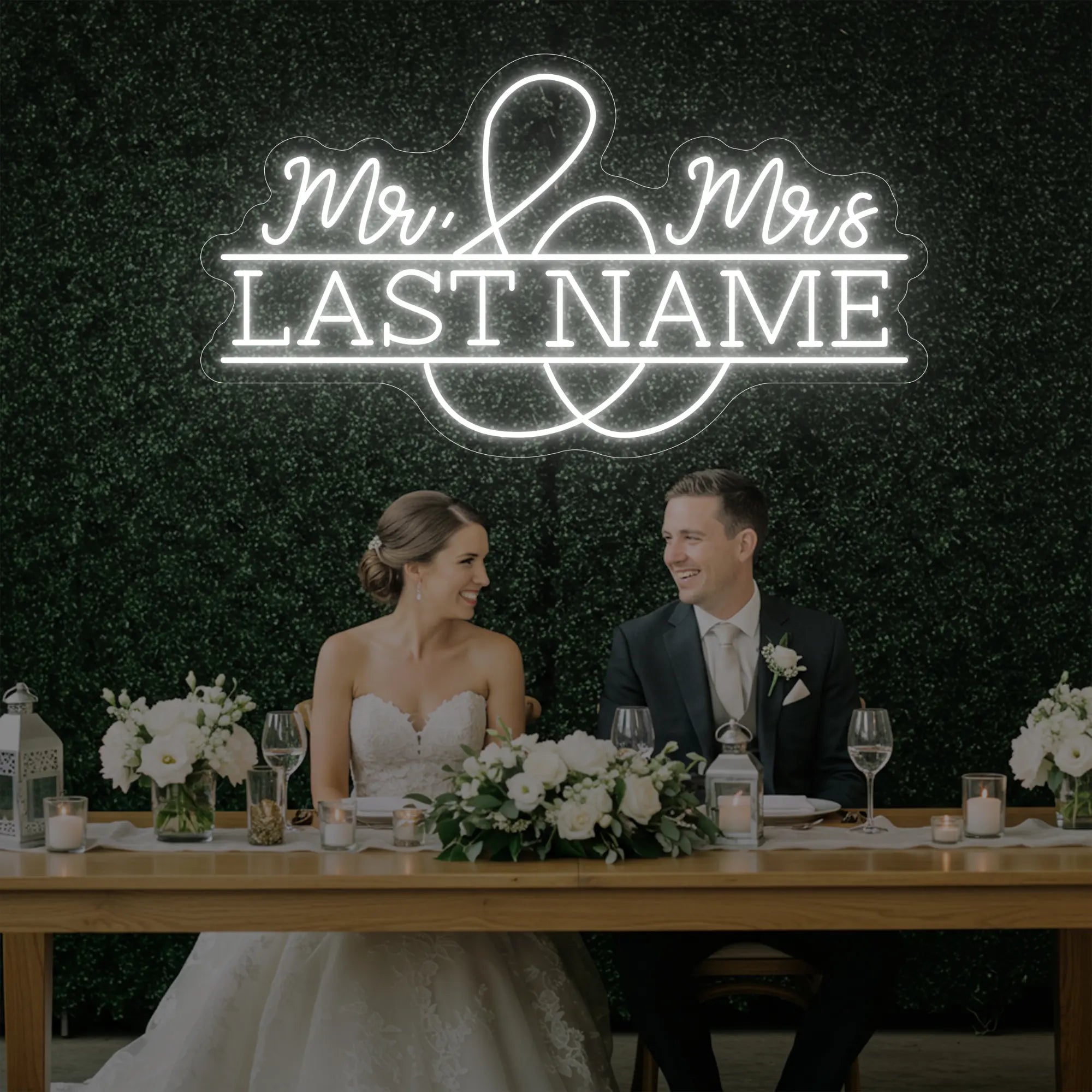 Photo of the 'Wedding Last Names Custom Neon Sign V6' neon sign glowing in cool white against a styled interior wall.