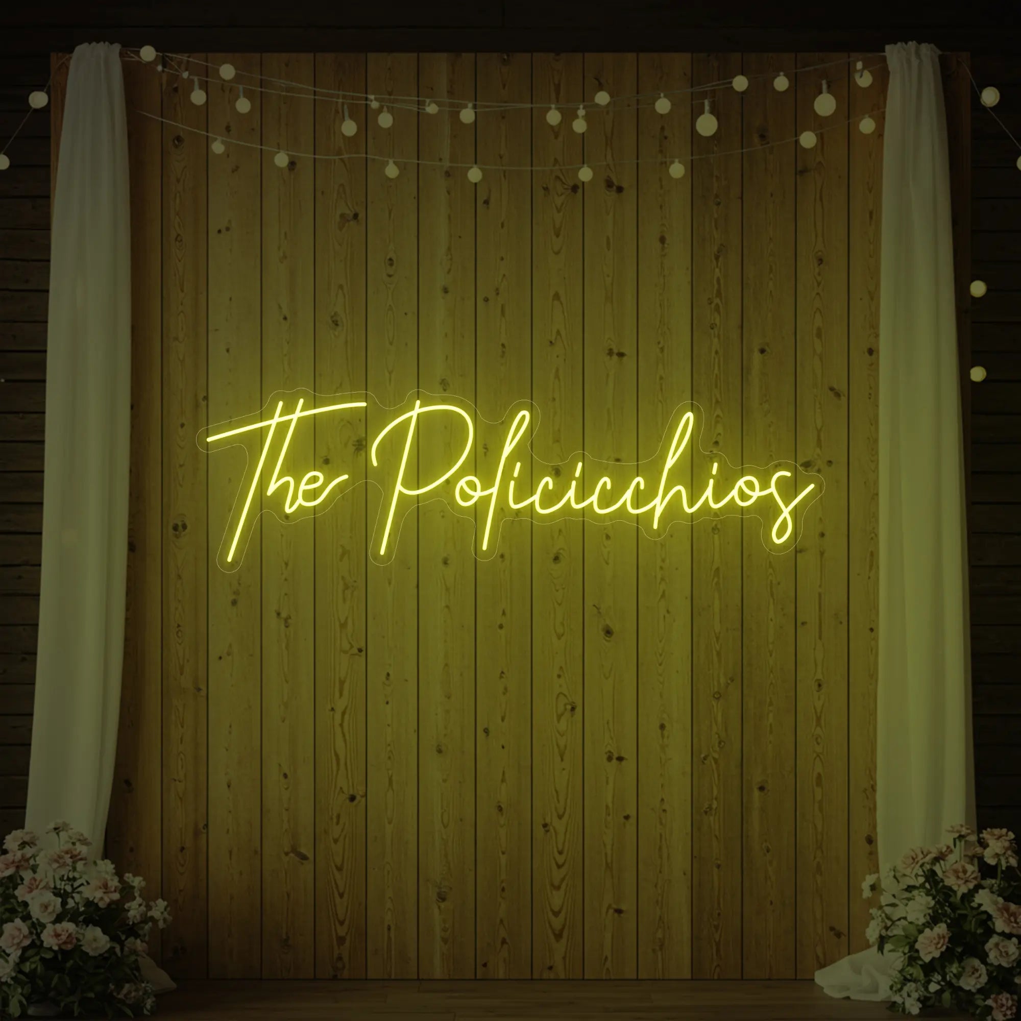 Photo of the 'Wedding Last Names Custom Neon Sign V7' neon sign glowing in lemon yellow against a styled interior wall.
