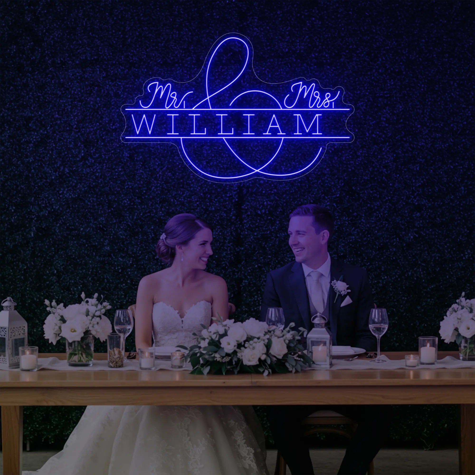 Photo of the 'Wedding Last Names Custom Neon Sign V3' neon sign glowing in deep blue against a styled interior wall.