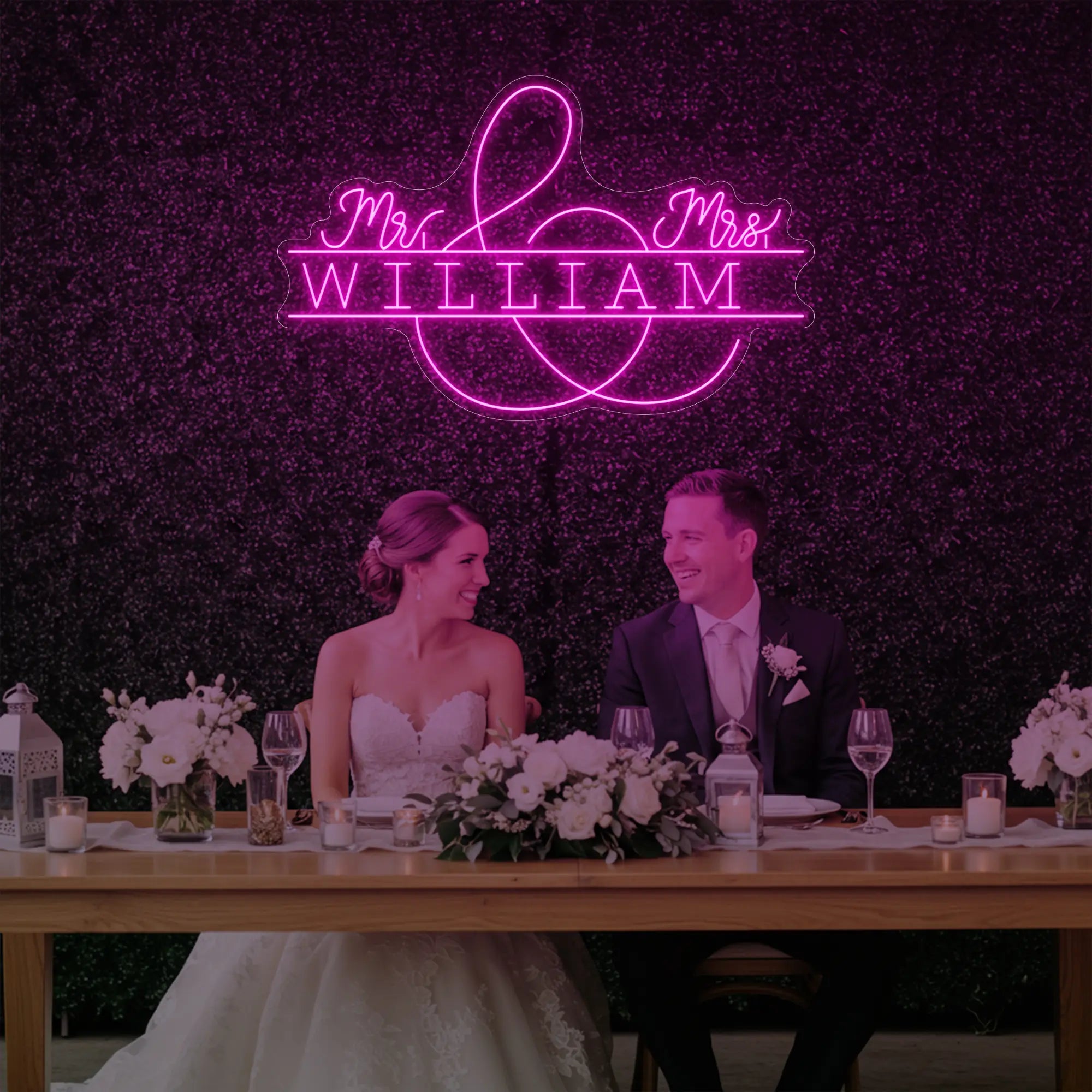 Photo of the 'Wedding Last Names Custom Neon Sign V3' neon sign glowing in light pink against a styled interior wall.
