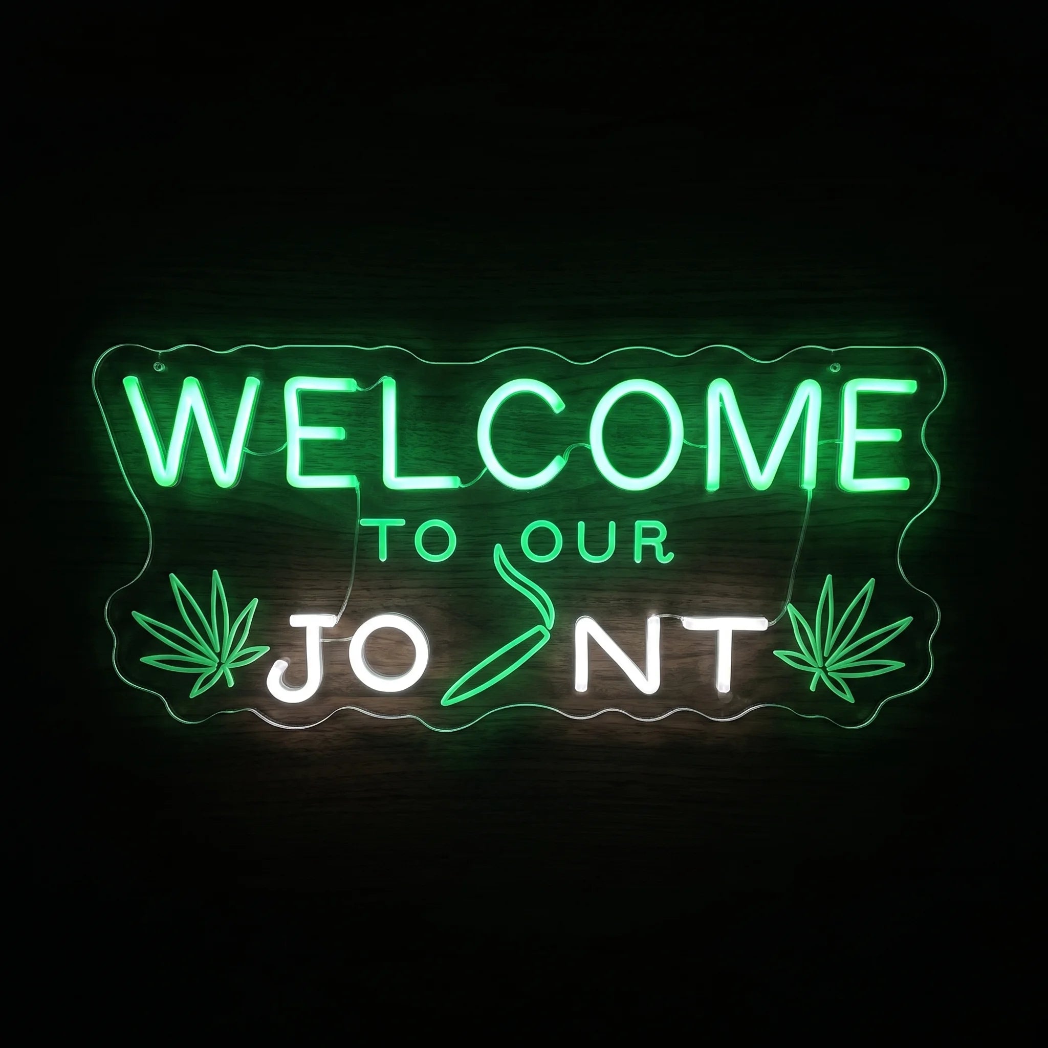 Welcome To Your Joint LED neon sign featuring green and white lettering with cannabis leaves and a pre-roll graphic on a clear acrylic backing.
