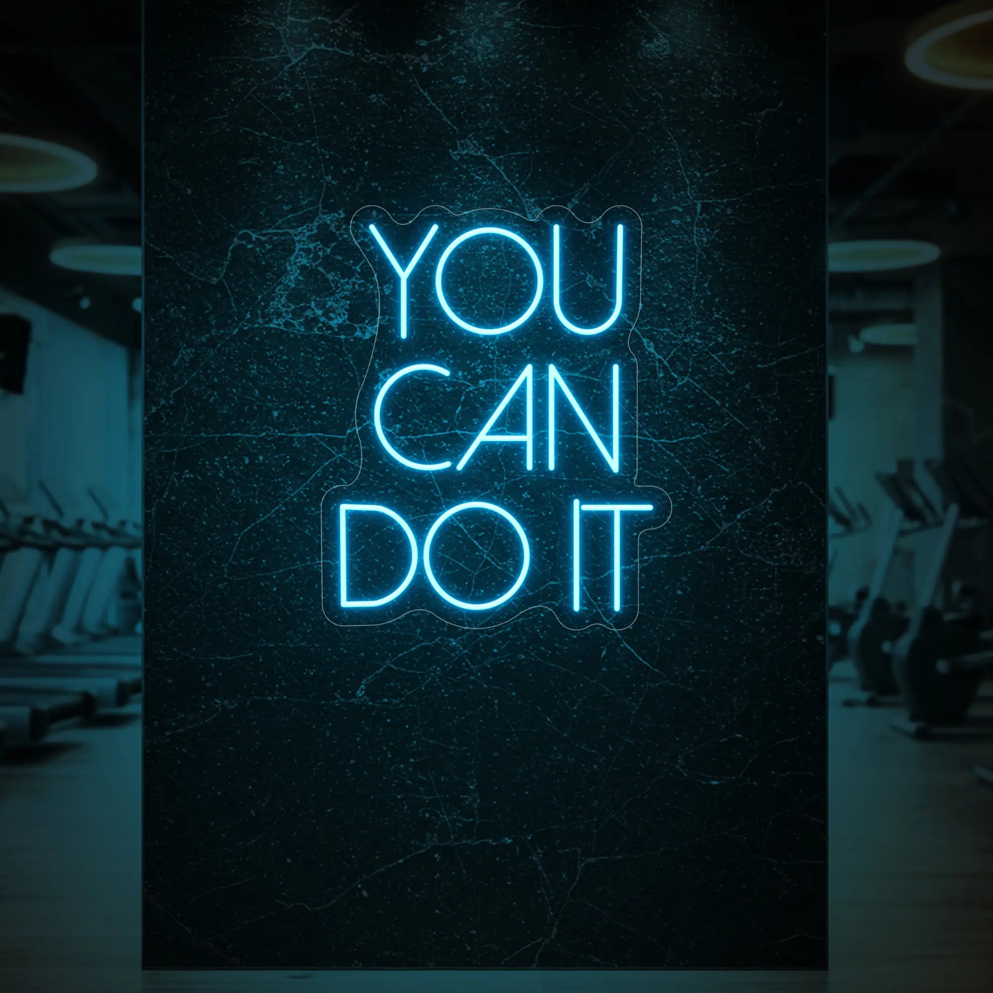 'YOU CAN DO IT' neon sign glowing in ice blue against a styled interior wall.