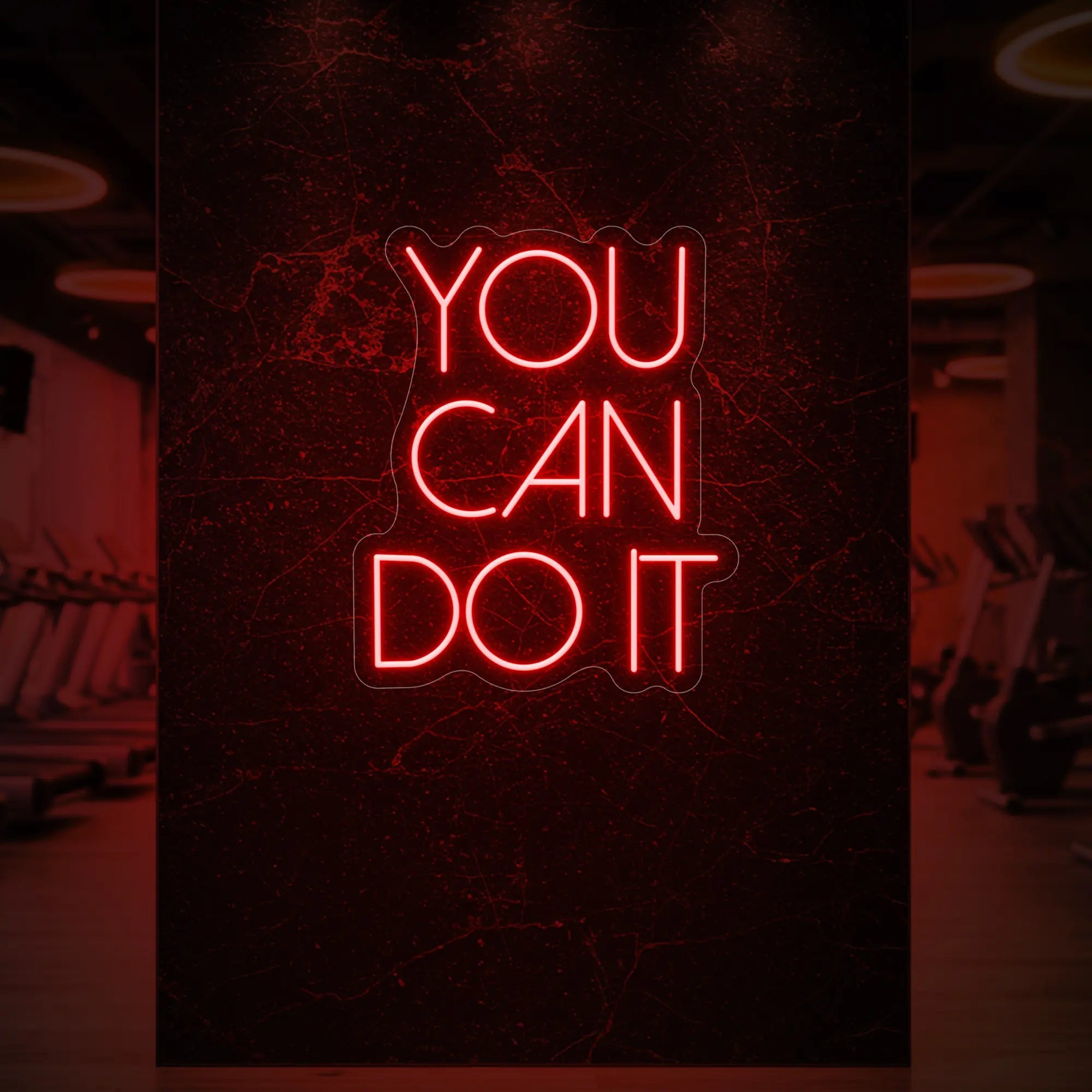 Photo of the 'YOU CAN DO IT' neon sign glowing in red against a styled interior wall.