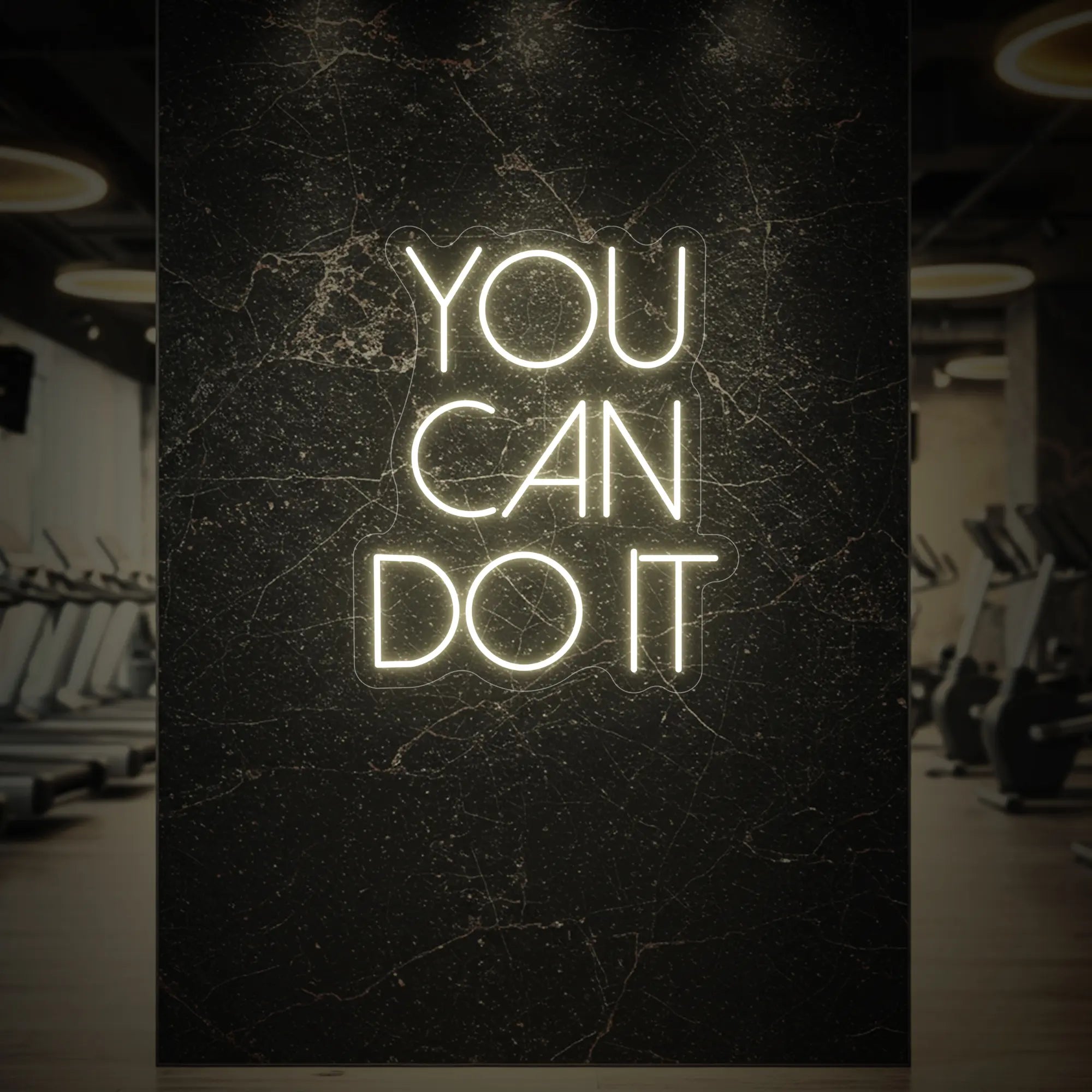 'YOU CAN DO IT' neon sign glowing in warm white against a styled interior wall.