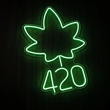 420 Leaf Emblem LED neon sign featuring a glowing green cannabis leaf above the number 420 on a clear acrylic backing.
