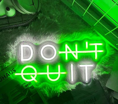 Green "DON'T QUIT" neon sign