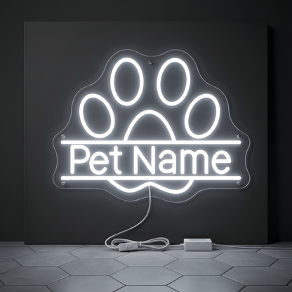Custom Paw Pet Name LED Neon Sign featuring a glowing white paw print with a personalized pet name illuminated across the center on clear acrylic backing, ideal for dog and cat owners, pet rooms, grooming salons, veterinary clinics, pet boutiques, and personalized pet gifts