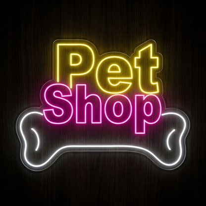 Pet Shop Bone LED Neon Sign featuring bright yellow Pet lettering, vibrant pink Shop text, and a large glowing white dog bone outline on clear acrylic backing, ideal for pet stores, pet supply shops, dog boutiques, pet care businesses, storefront windows, and animal-themed retail spaces
