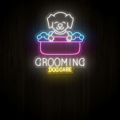 Dog Grooming Care LED Neon Sign featuring a cute white neon dog inside a bright pink grooming tub with blue bubble accents, white Grooming lettering and yellow Dog Care text on clear acrylic against a dark wood wall.