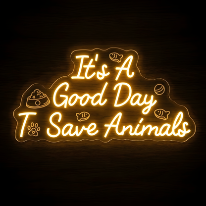 Save Animals Quote LED Neon Sign featuring the glowing phrase It’s A Good Day To Save Animals with paw print, pet food bowl, fish and ball details on clear acrylic backing against a dark wood wall.