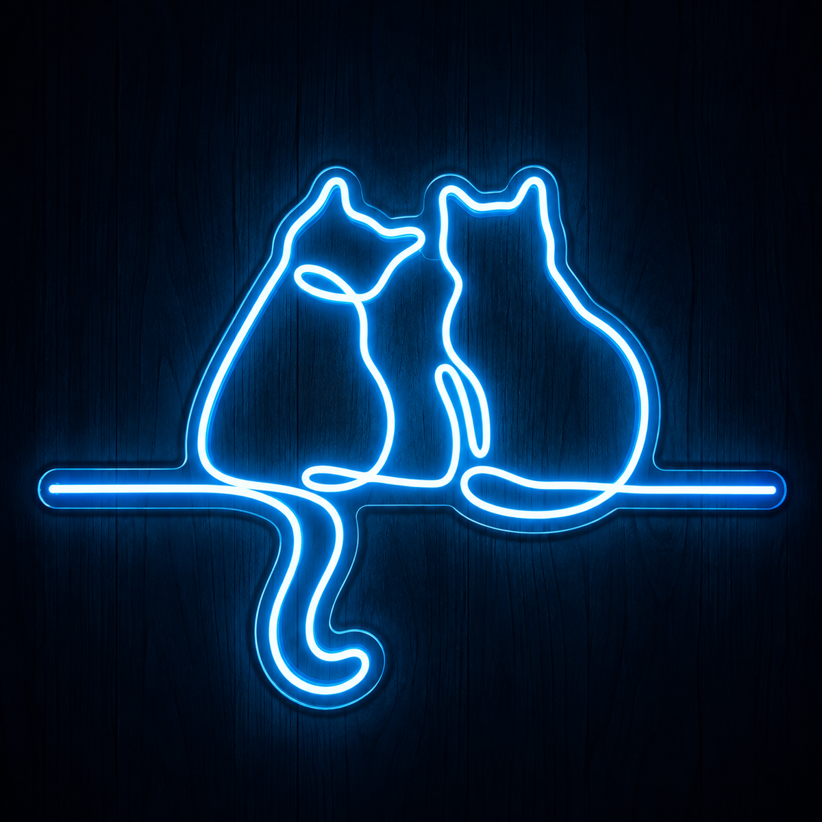 Two Cats Together LED Neon Sign featuring a bright blue continuous line-art design of two cats sitting side by side on clear acrylic backing against a dark wood wall.