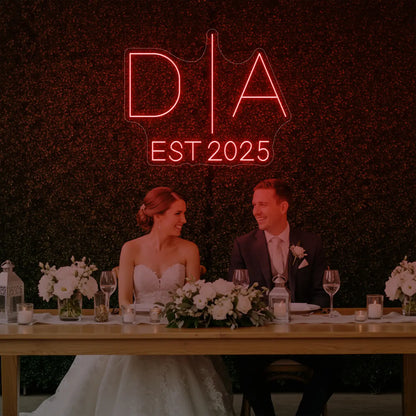 Photo of the 'Wedding Initials Custom Neon Sign V3' neon sign glowing in red against a styled interior wall.