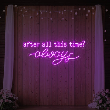 Photo of the 'After All This Time V1' neon sign glowing in deep pink against a styled interior wall.
