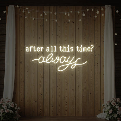 Photo of the 'After All This Time V1' neon sign glowing in warm white against a styled interior wall.
