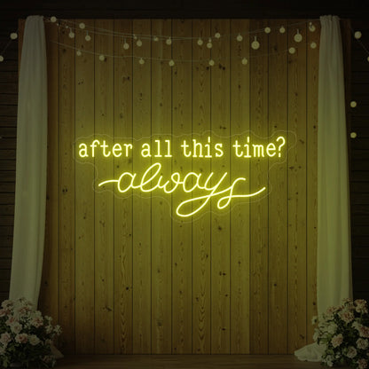 Photo of the 'After All This Time V1' neon sign glowing in lemon yellow against a styled interior wall.