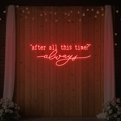 Photo of the 'After All This Time V2' neon sign glowing in red against a styled interior wall.
