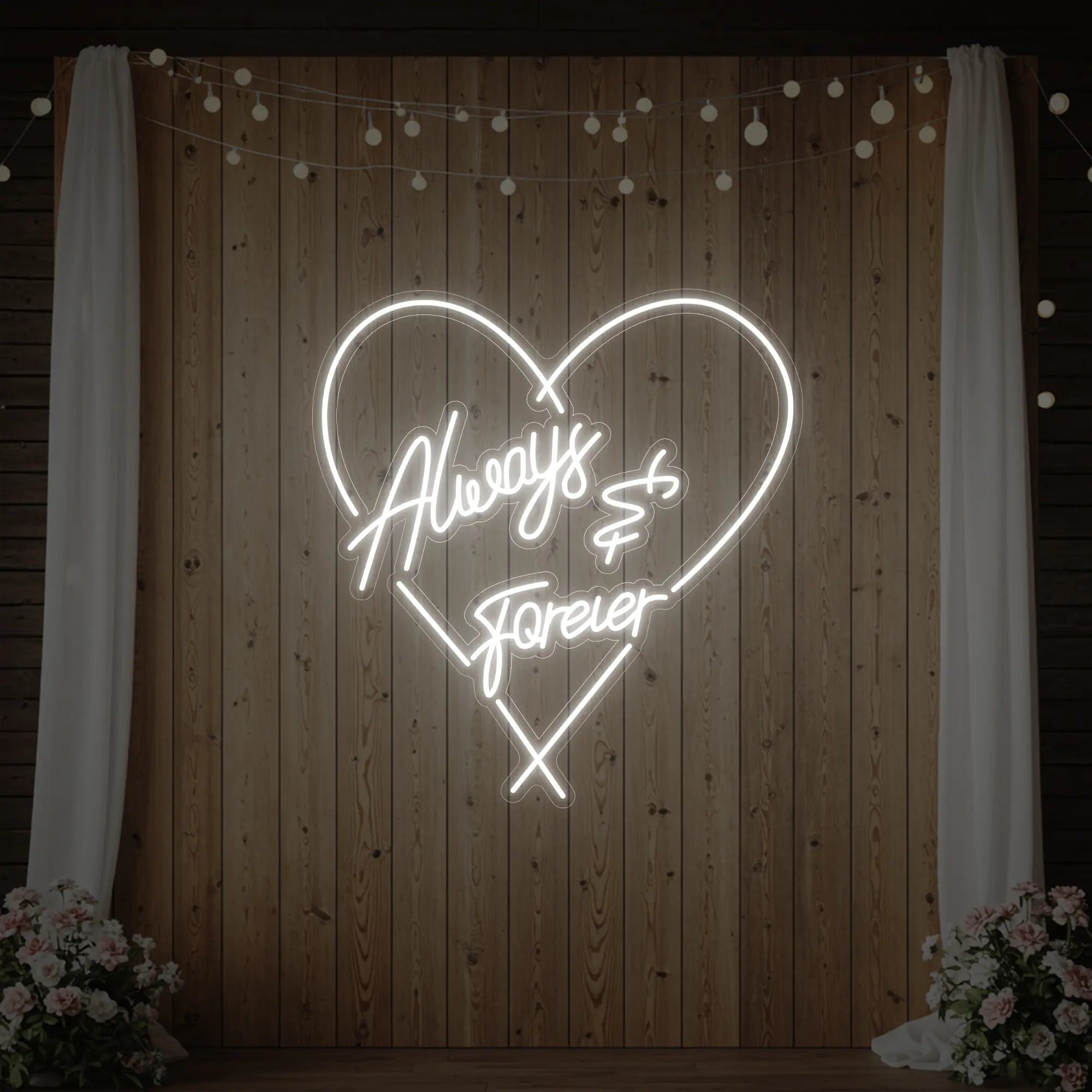 Photo of the 'Always & Forever' neon sign glowing in cool white against a styled interior wall.