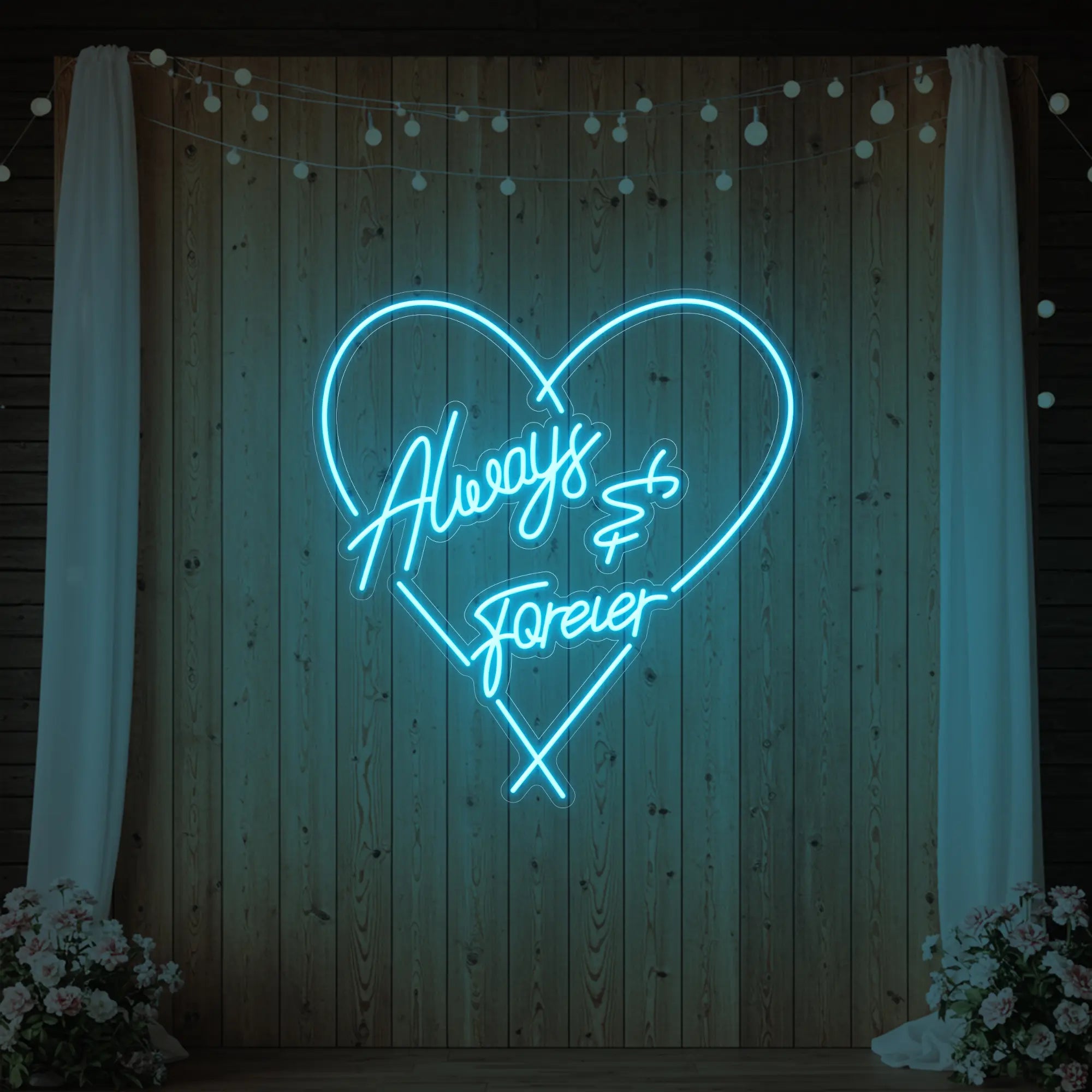 Photo of the 'Always & Forever' neon sign glowing in ice blue against a styled interior wall.