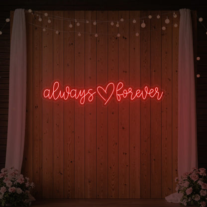Photo of the 'Always Heart Forever' neon sign glowing in red against a styled interior wall.