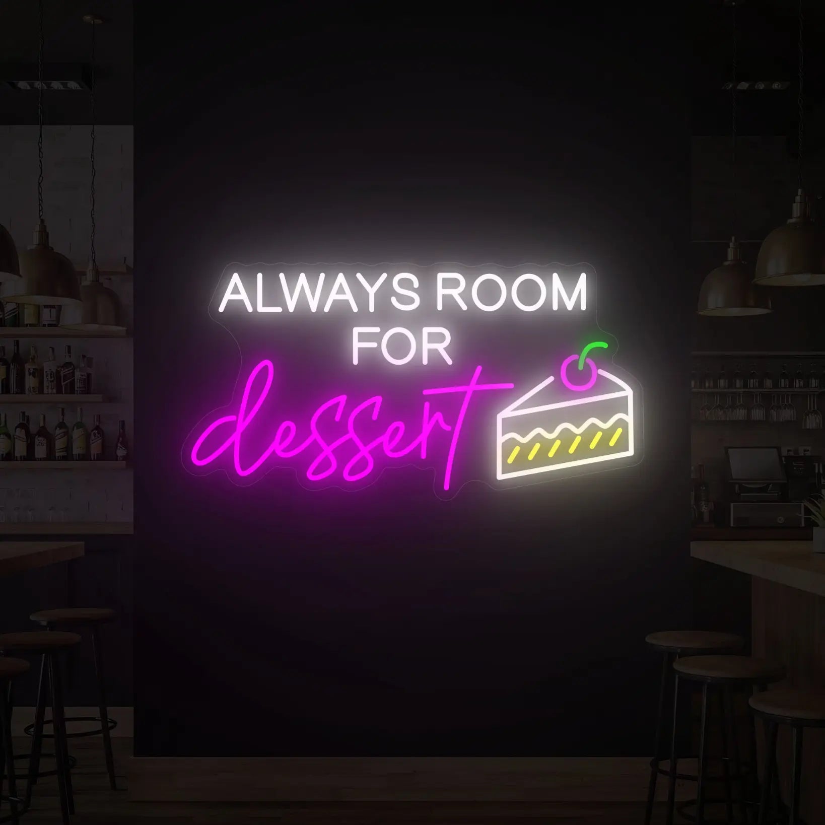 Photo of the 'ALWAYS ROOM FOR DESSERT' neon sign glowing in multi-color against a styled interior wall.